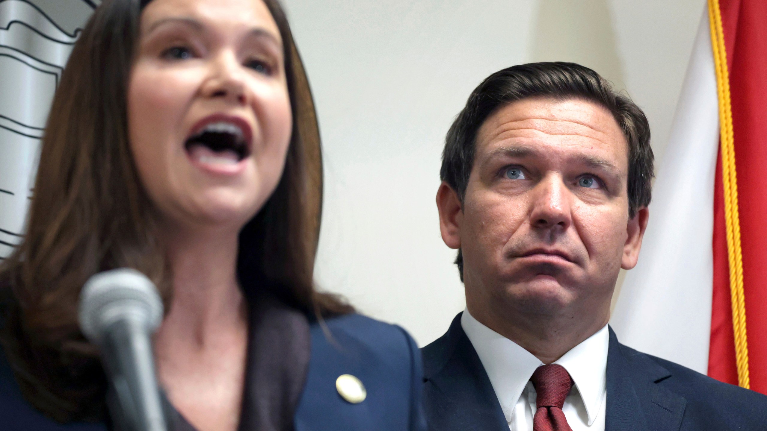 FILE - Florida Gov. Ron DeSantis listens to Florida Attorney General Ashley Moody during a news conference in Orlando, Fla., Aug. 26, 2021. (Joe Burbank/Orlando Sentinel via AP, file)