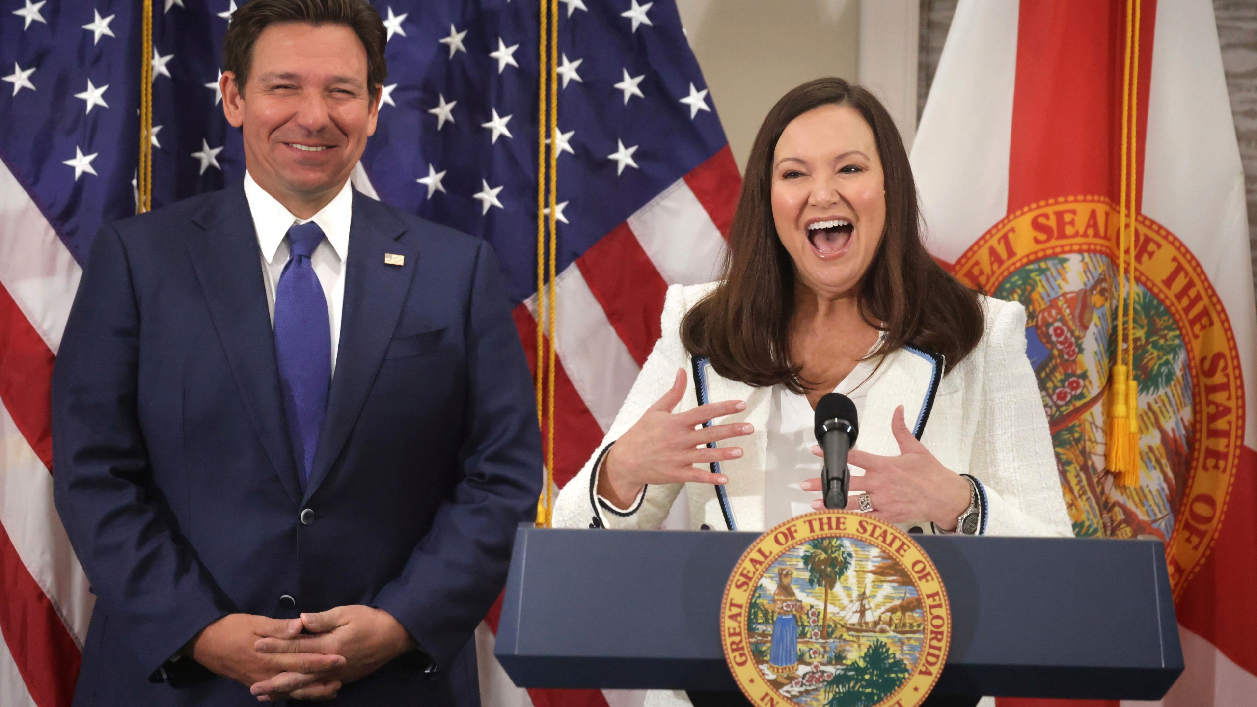 Florida Attorney General Ashley Moody responds to cheering supporters after Gov. Ron DeSantis, left, announced her appointment as U.S. senator to replace Marco Rubio, during a press conference at the Rosen Plaza Hotel in Orlando, Fla., Thursday, Jan. 16, 2024. (Joe Burbank/Orlando Sentinel via AP)