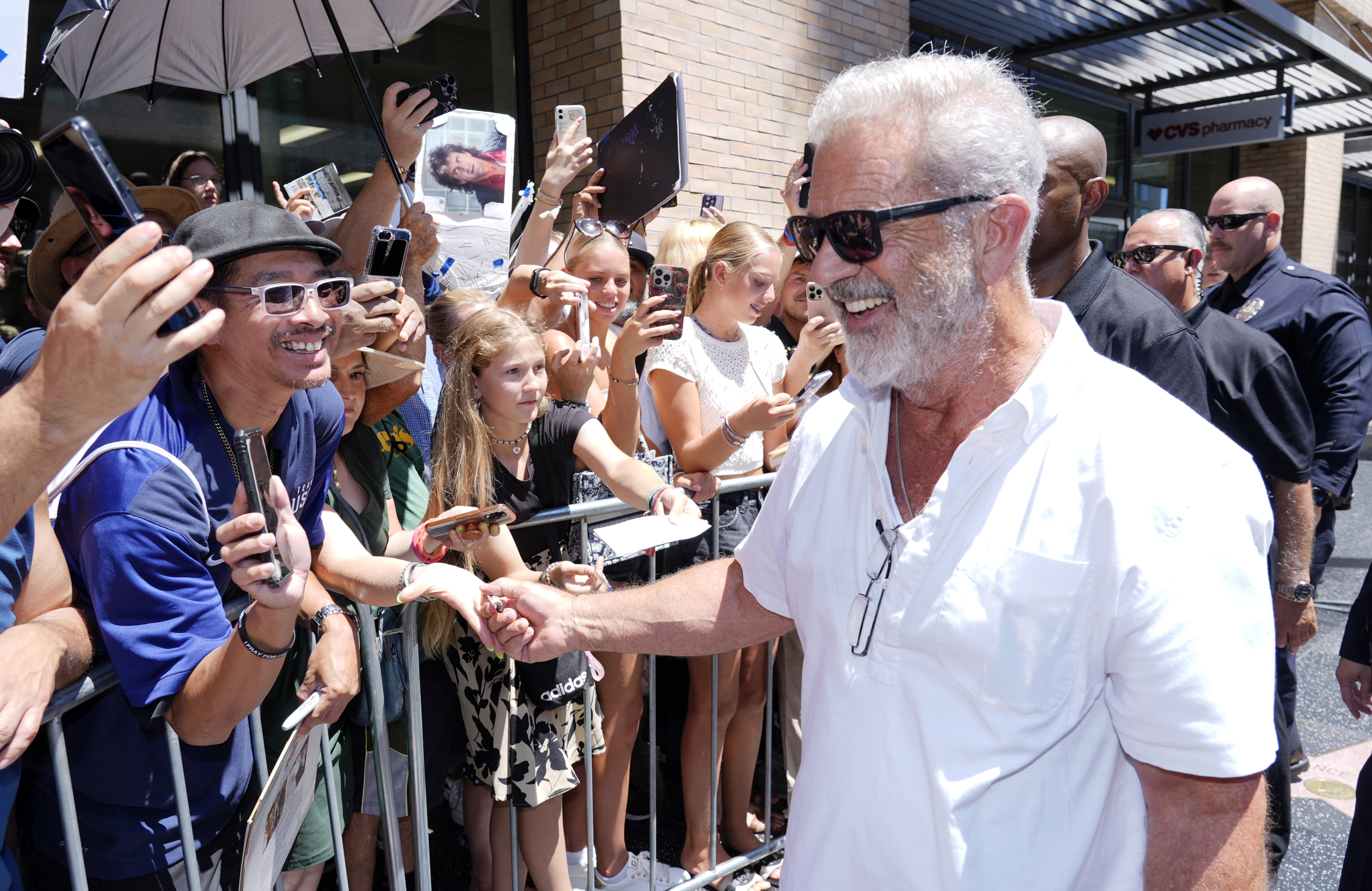 FILE - Mel Gibson, right, interacts with crowd members as he leaves a Hollywood Walk of Fame star ceremony for actor Vince Vaughn, on Aug. 12, 2024, in Los Angeles. (AP Photo/Chris Pizzello, File)