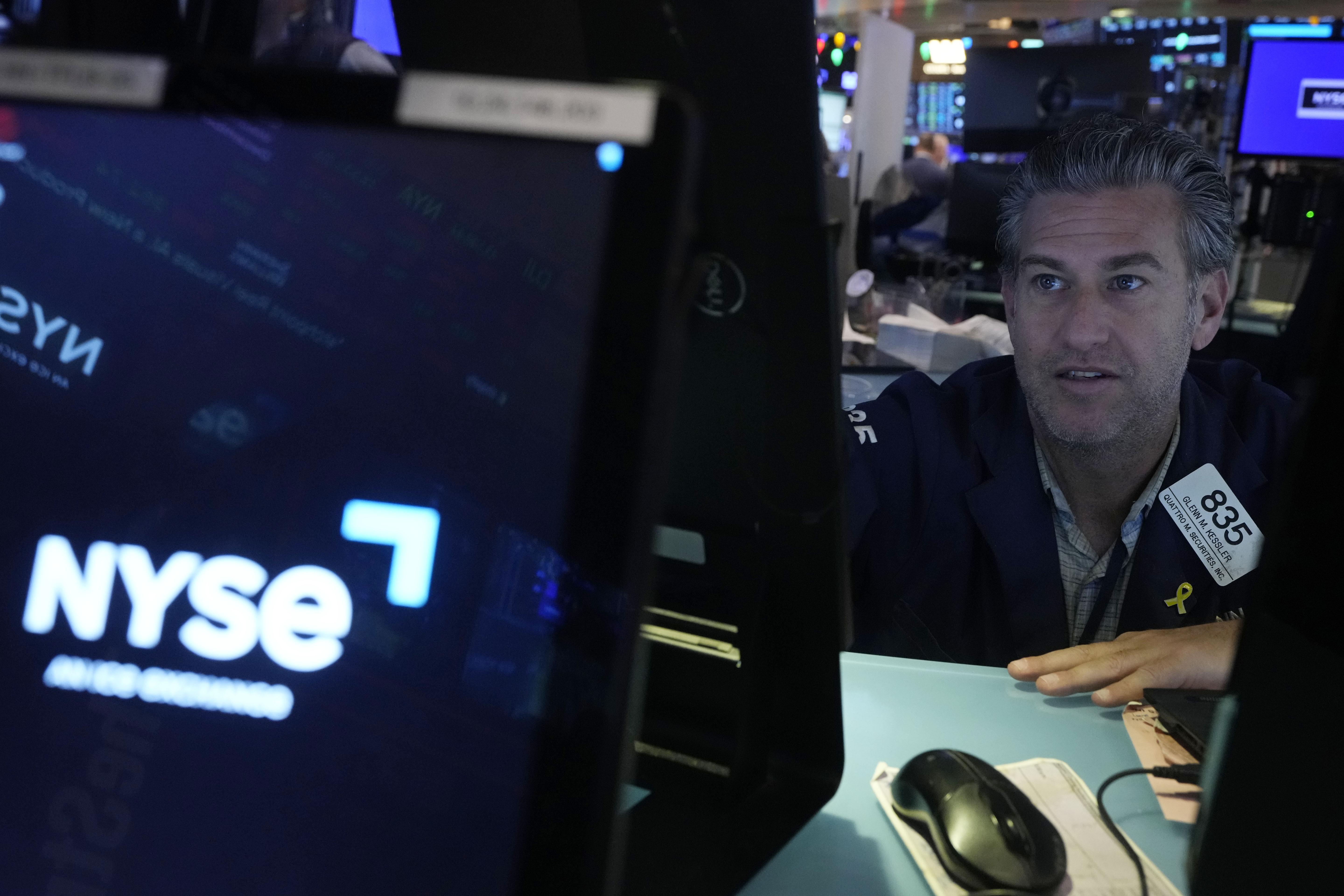 Trader Glenn Kessler works on the floor of the New York Stock Exchange, Wednesday, Dec. 18, 2024. (AP Photo/Richard Drew)