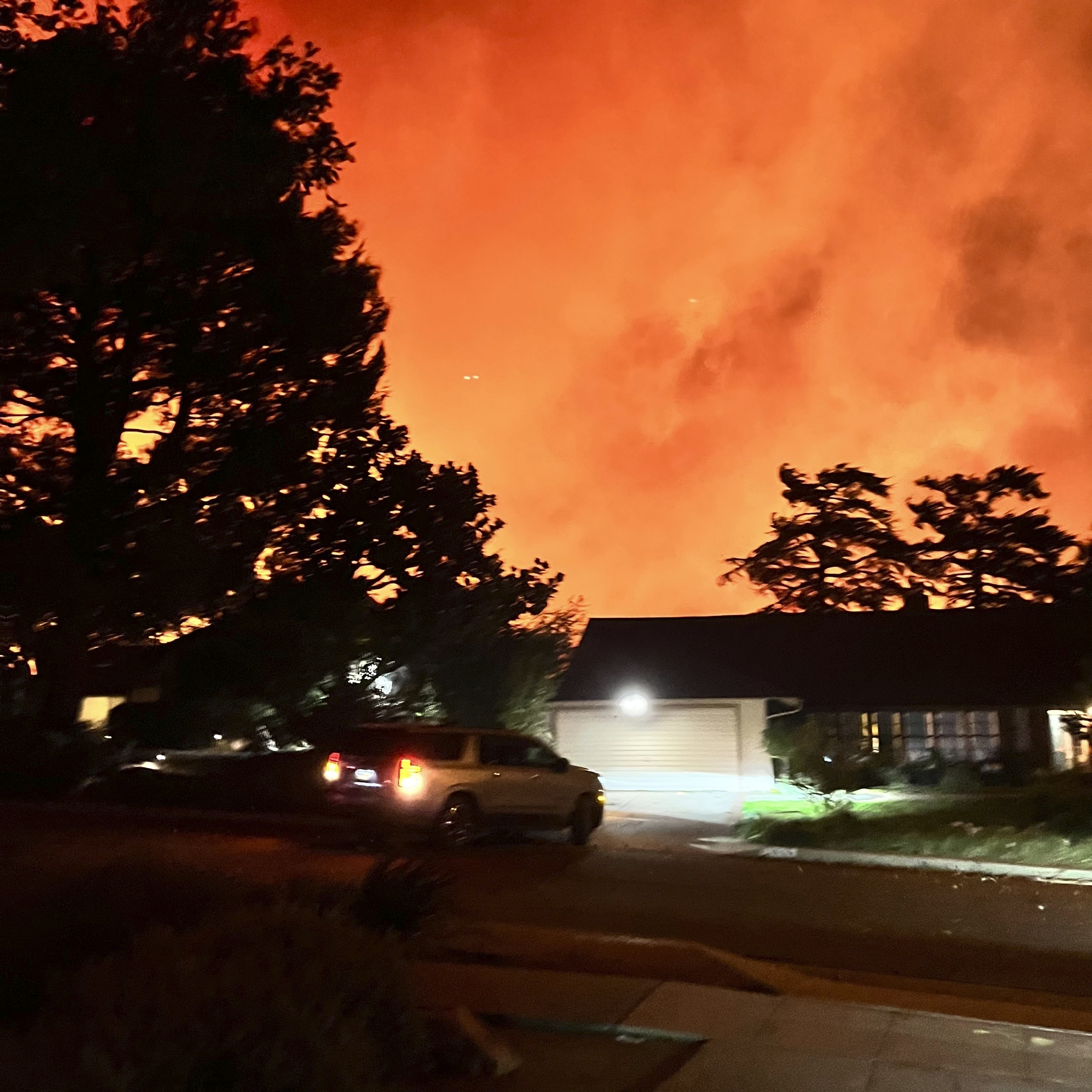 In this photo provided by Pasadena, Calif., resident Matt Logelin, flames burn arond transmission towers owned by Southern California Edison in Eaton Canyon in the early evening of Tuesday, Jan. 7, 2025. (Matt Logelin via AP)