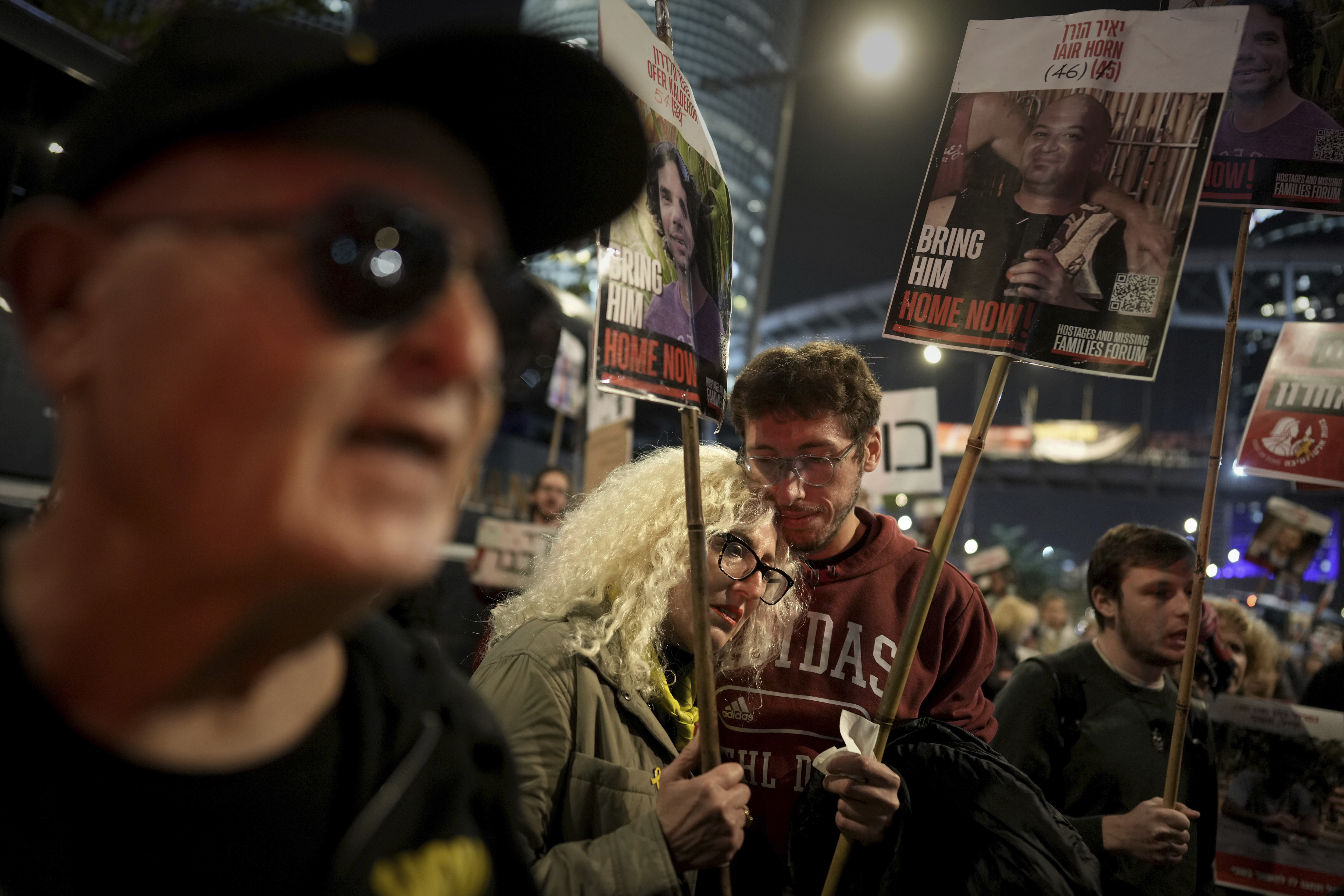 Relatives and friends of people killed and abducted by Hamas and taken into Gaza, react to the ceasefire announcement as they take part in a demonstration in Tel Aviv, Israel, Wednesday, Jan. 15, 2025. (AP Photo/Oded Balilty)