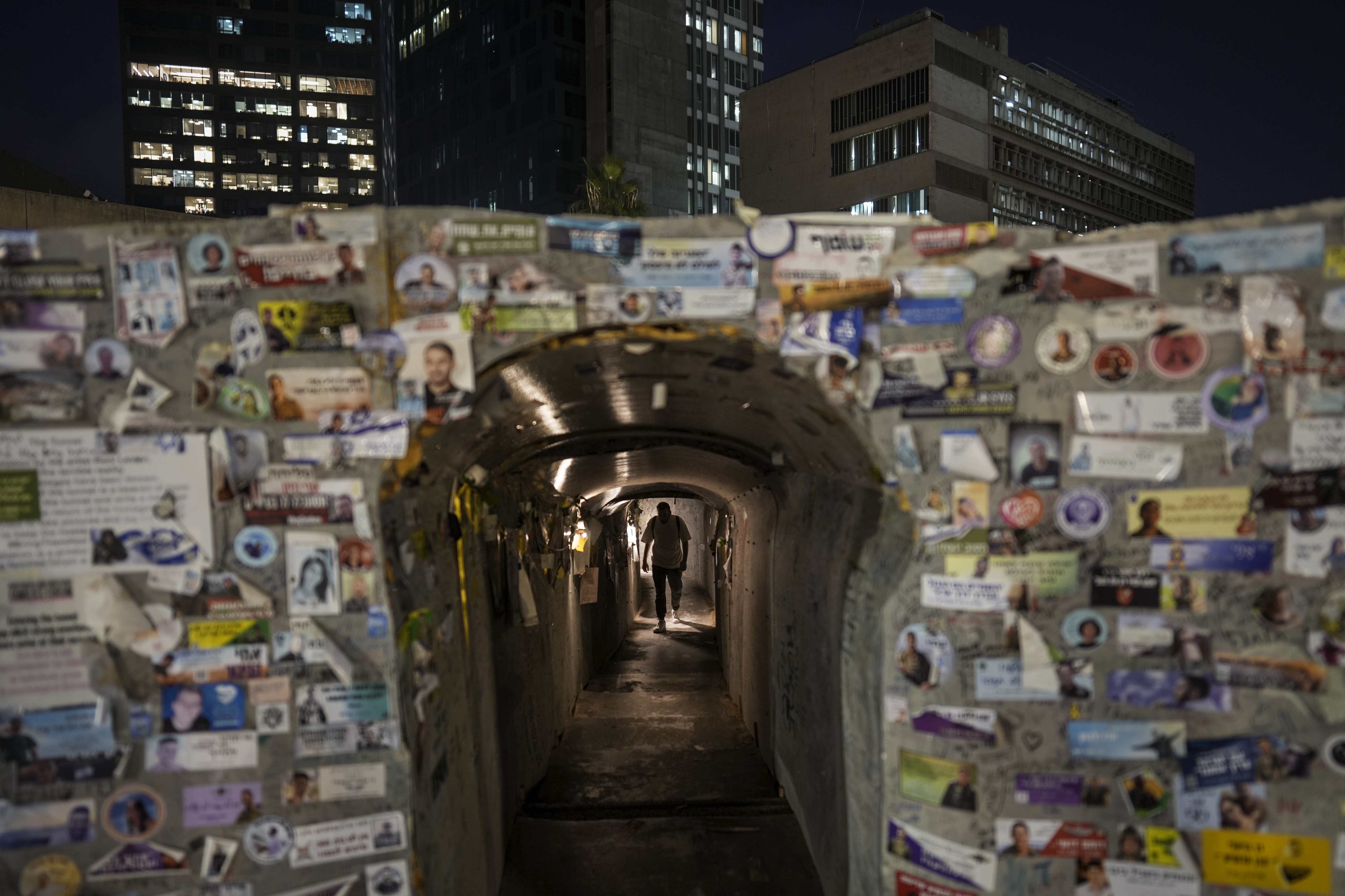 FILE - An Israeli man walks through an installation simulating a tunnel in Gaza in an act of solidarity with hostages believed to be held underground by Hamas and calling for their return, in Tel Aviv, Israel, Wednesday, Jan. 15, 2025. (AP Photo/Oded Balilty, File)