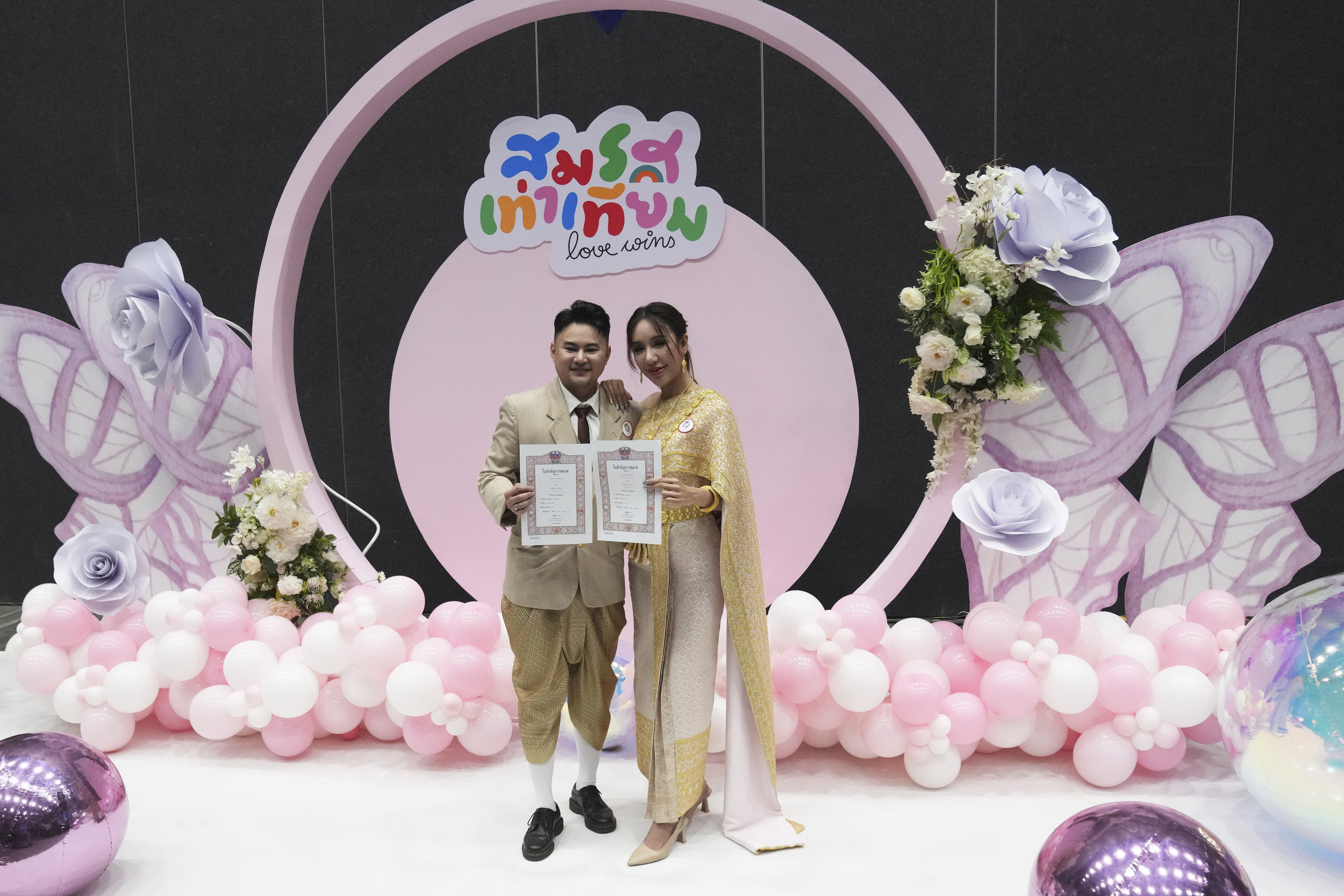 A couple from the LGBTQ+ community shows their marriage certificate in Bangkok, Thailand, Thursday, Jan. 23, 2025. (AP Photo/Sakchai Lalit)