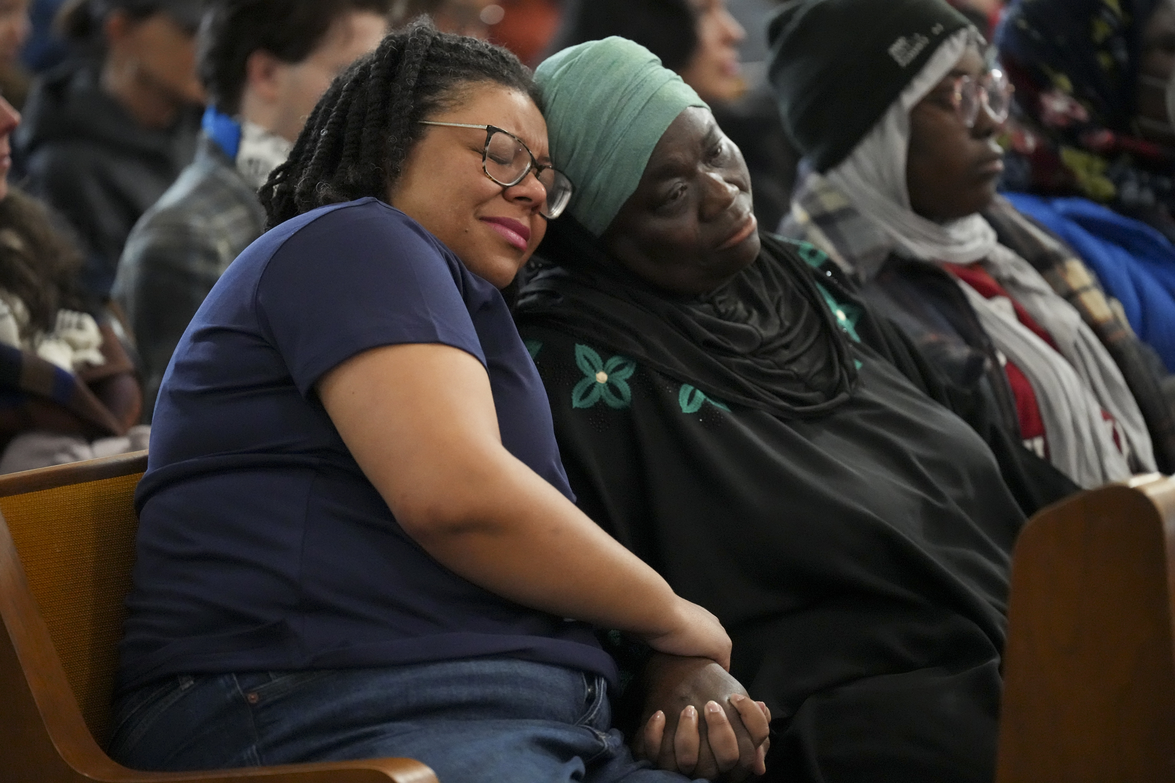 Metro Nashville council members Delishia Porterfield, left, and Zulfat Suara, right, console each other during a vigil for students that were killed and injured in a school shooting Wednesday, Jan. 22, 2025, in Nashville, Tenn. (AP Photo/George Walker IV)