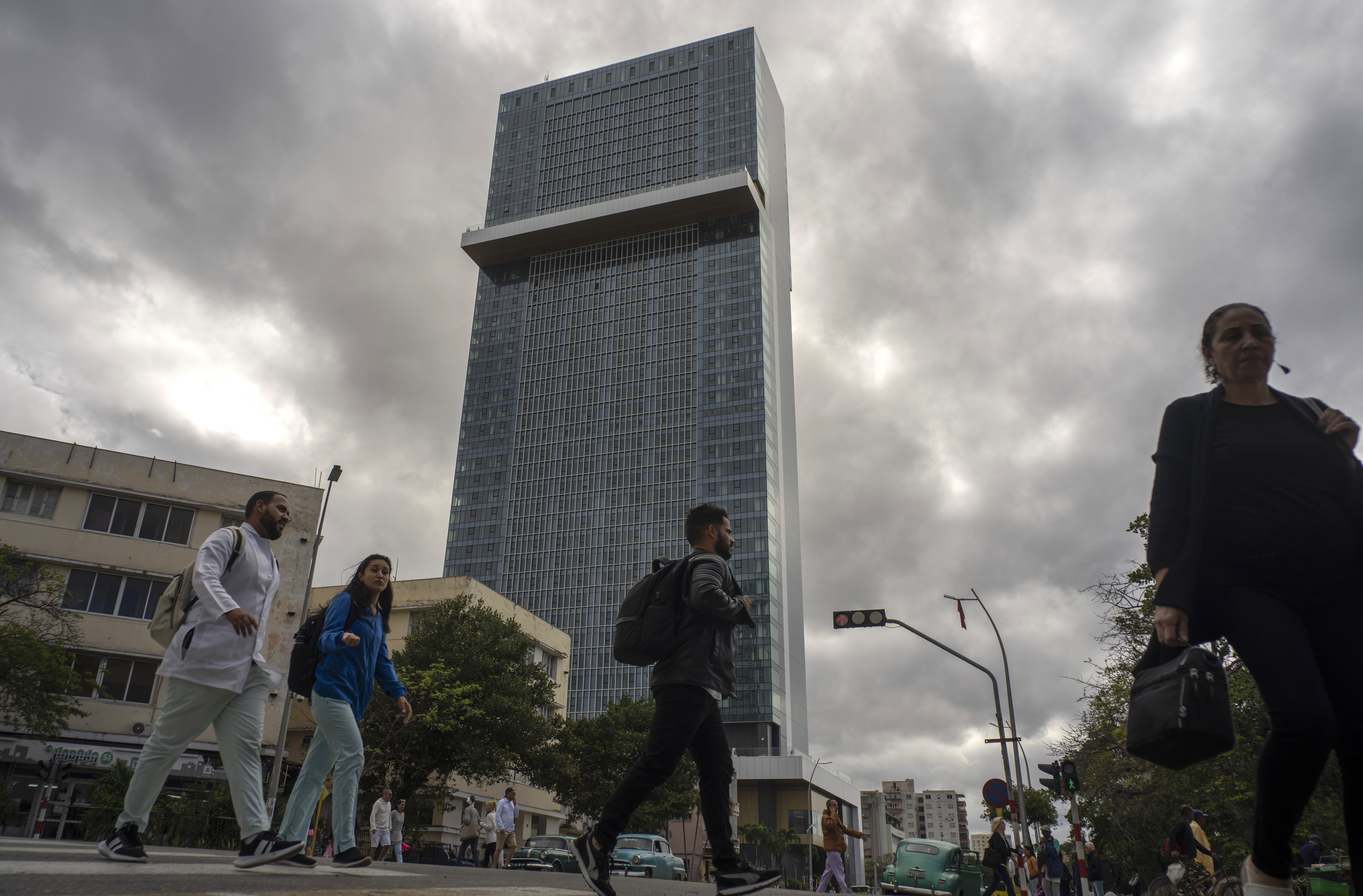 People walk past the Selection La Habana new hotel, managed by Spanish chain Iberostar, in Havana, Cuba, Friday, Jan. 24, 2025. (AP Photo/Ramon Espinosa)