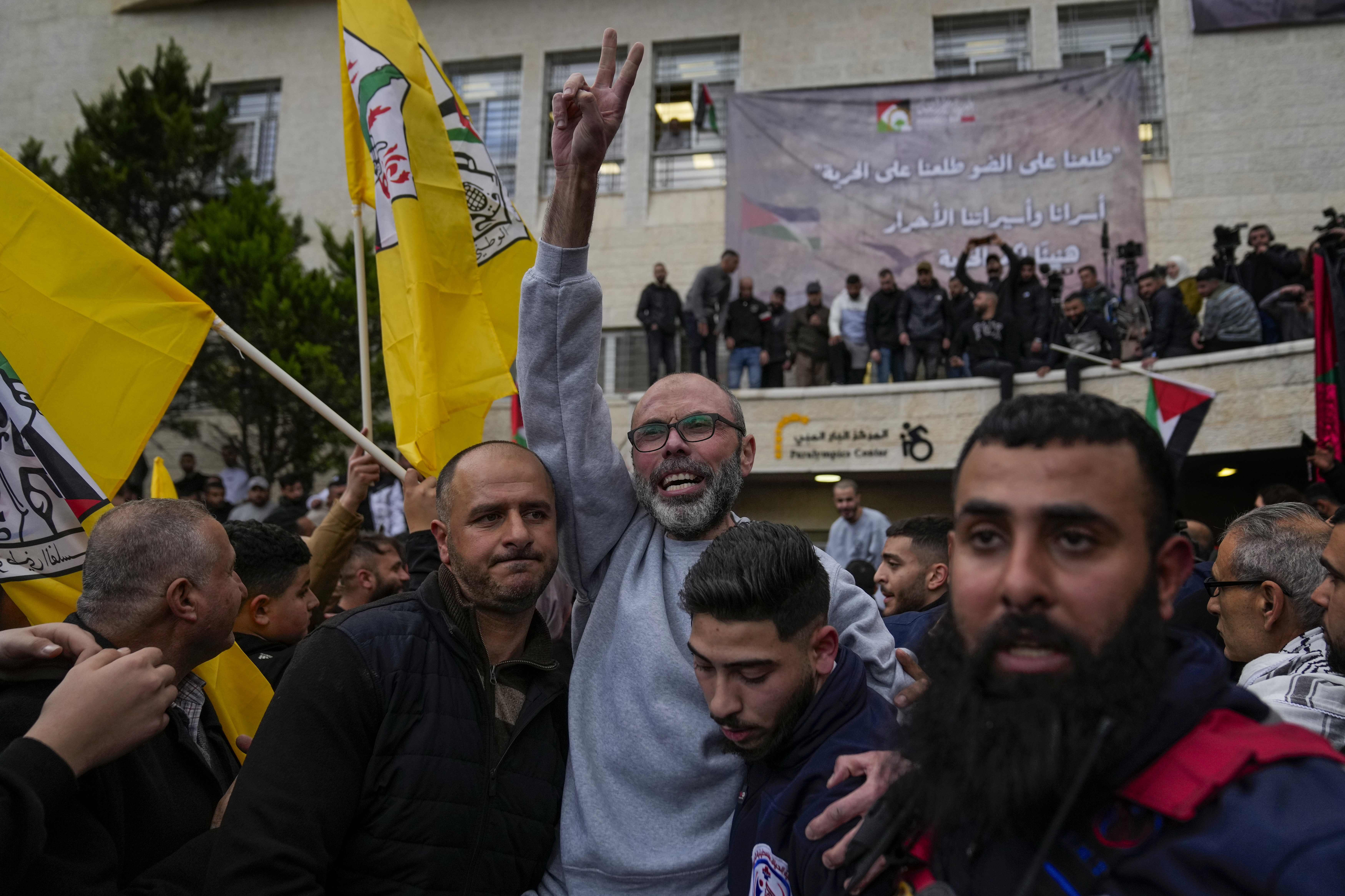 Palestinian prisoners are greeted by a crowd after being released from Israeli prison following a ceasefire agreement with Israel, in the West Bank city of Ramallah, Saturday, Jan. 25, 2025. (AP Photo/Nasser Nasser)