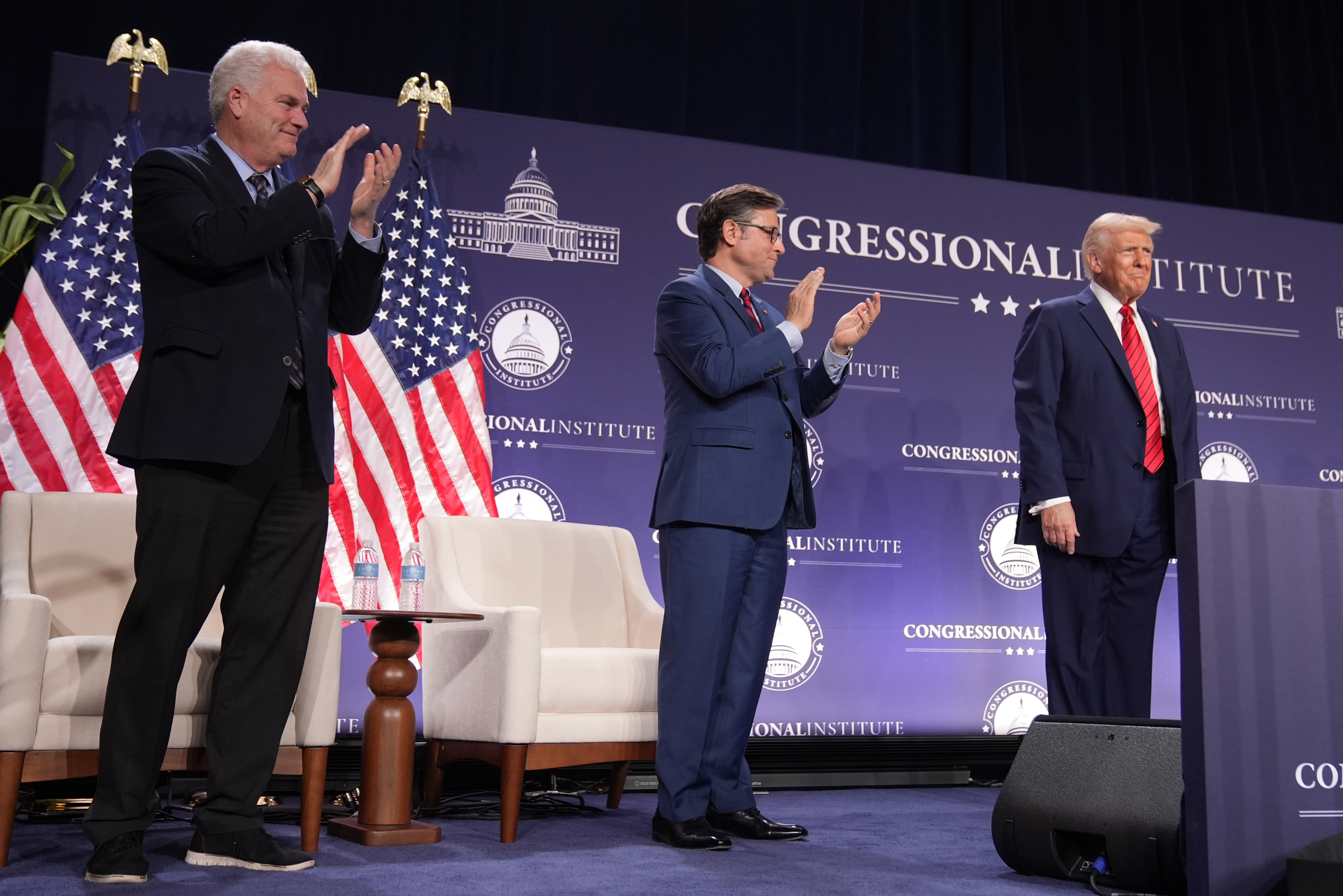 Rep. Tom Emmer, R-Minn., left, and House Speaker Mike Johnson of La., applaud President Donald Trump at the 2025 House Republican Members Conference Dinner at Trump National Doral Miami in Doral, Fla., Monday, Jan. 27, 2025. (AP Photo/Mark Schiefelbein)