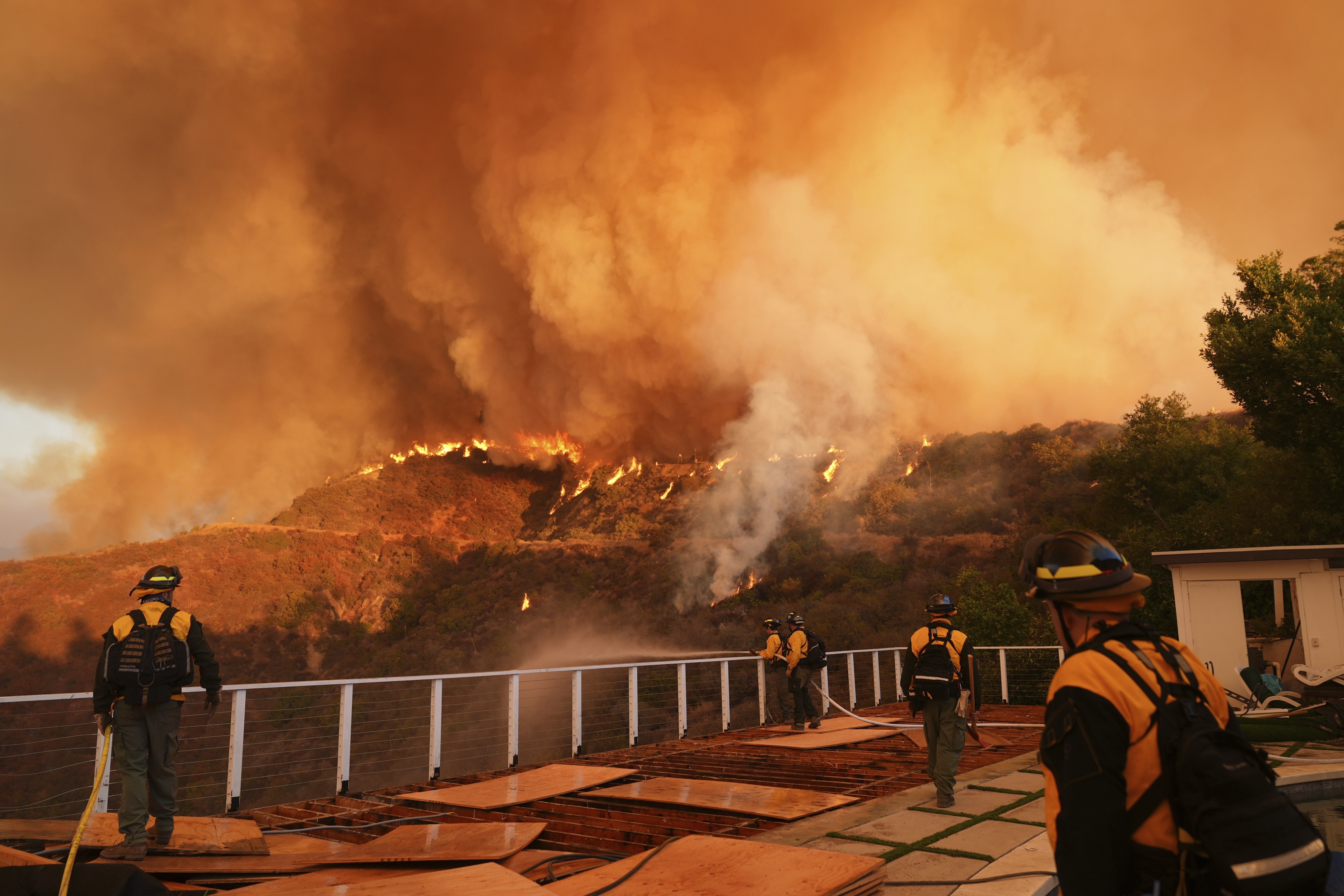 FILE - Fire crews monitor the Palisades Fire in Mandeville Canyon, Jan. 11, 2025, in Los Angeles. (AP Photo/Jae C. Hong, File)