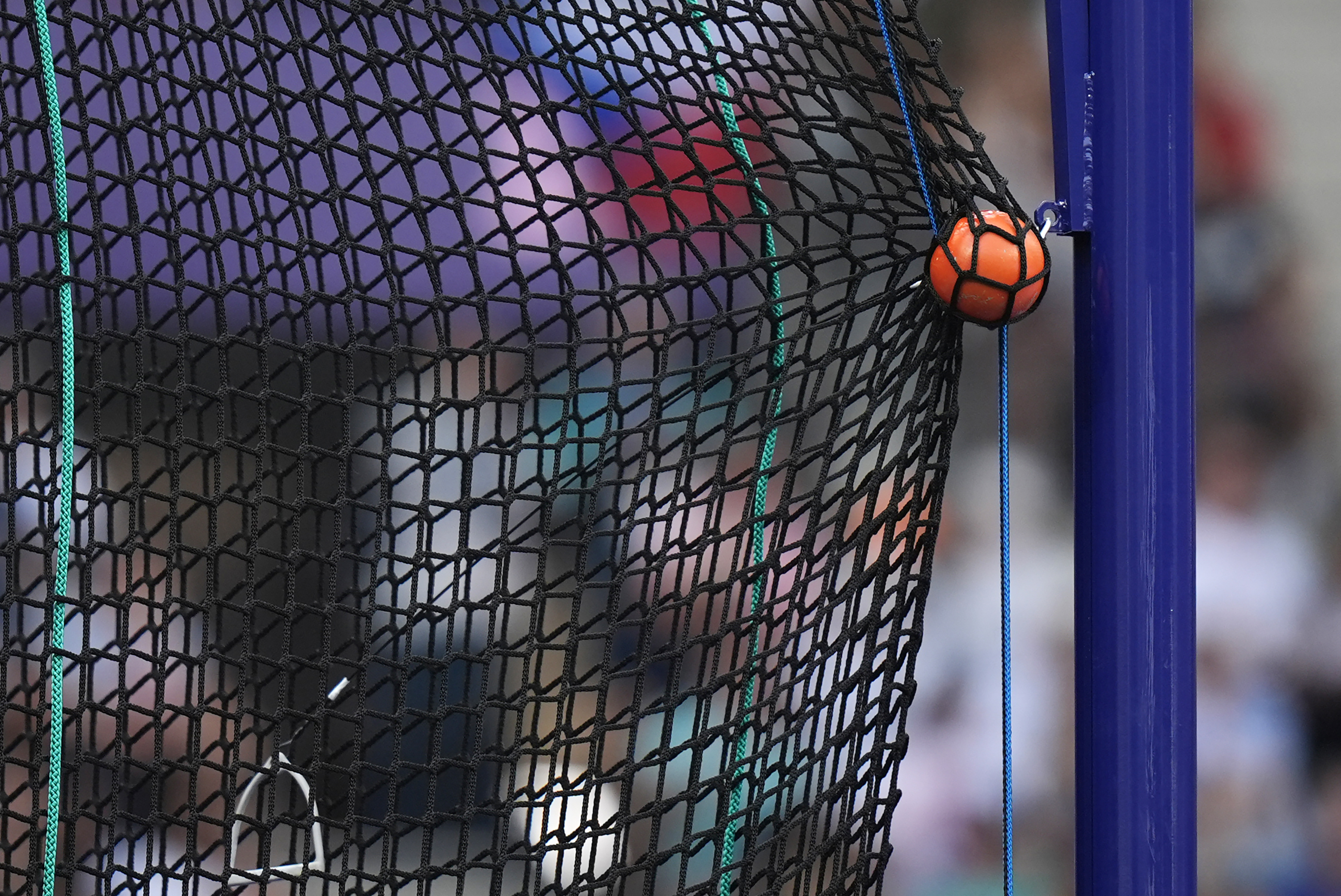 FILE - A hammer is caught by the safety net during the men's hammer throw qualification at the 2024 Summer Olympics, Aug. 2, 2024, in Saint-Denis, France. (AP Photo/Matthias Schrader, File)