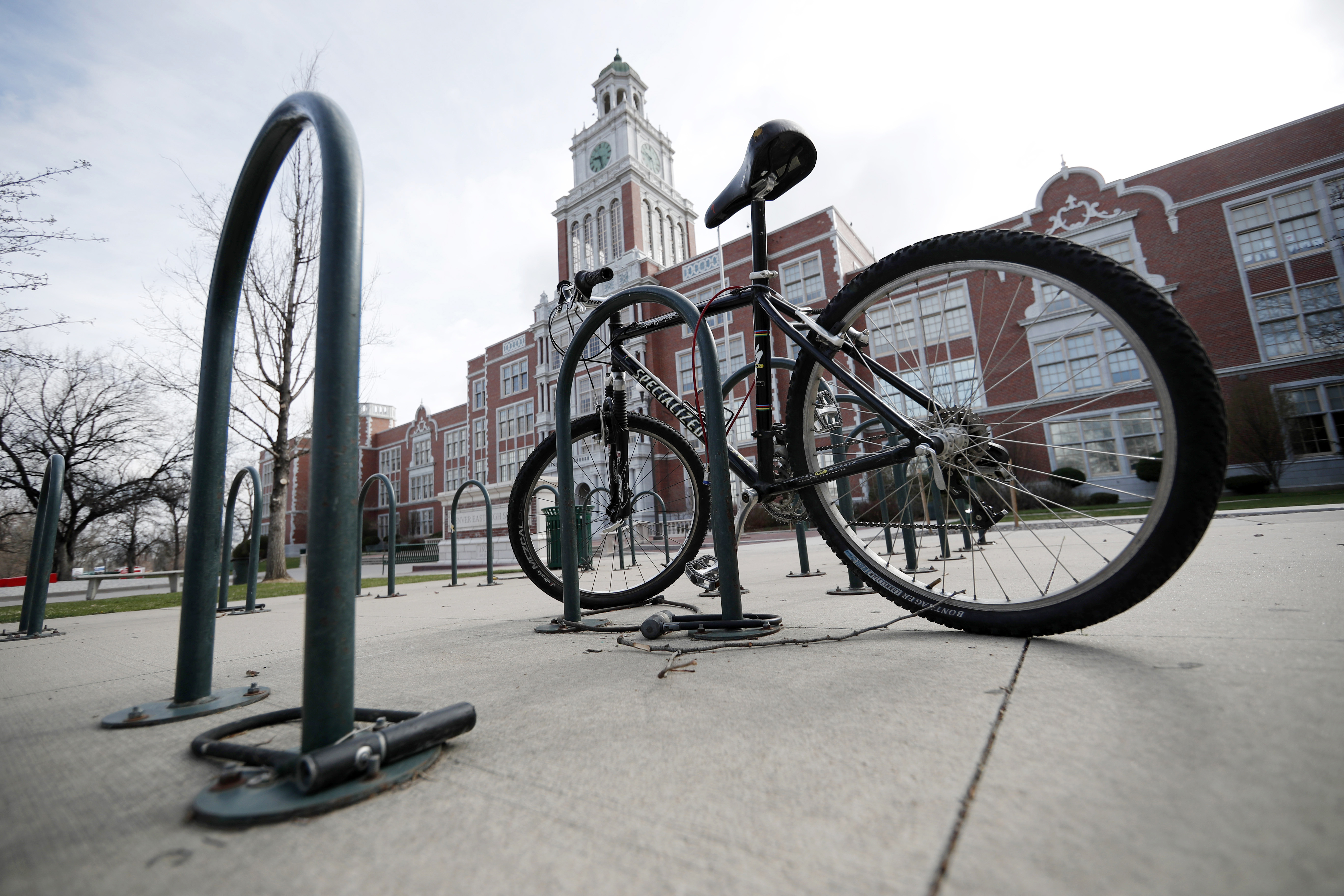 FILE — A lone bicycle stands in the rack outside East High School, Wednesday, April 17, 2019, in Denver. (AP Photo/David Zalubowski, File)