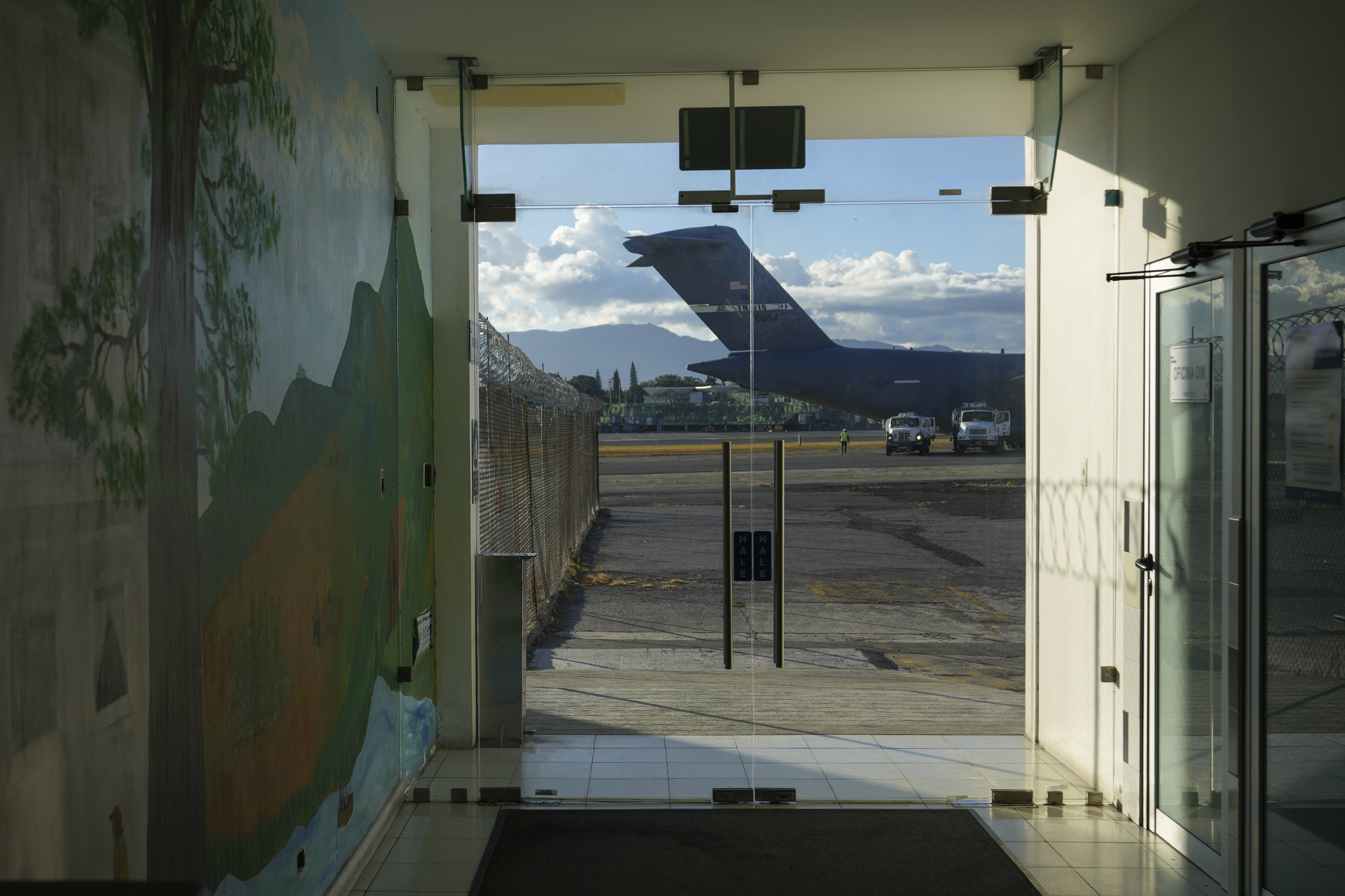 A U.S. military plane carrying Guatemalan migrants deported from the United States sits on the tarmac at La Aurora airport in Guatemala City, Monday, Jan. 27, 2025. (AP Photo/Moises Castillo)