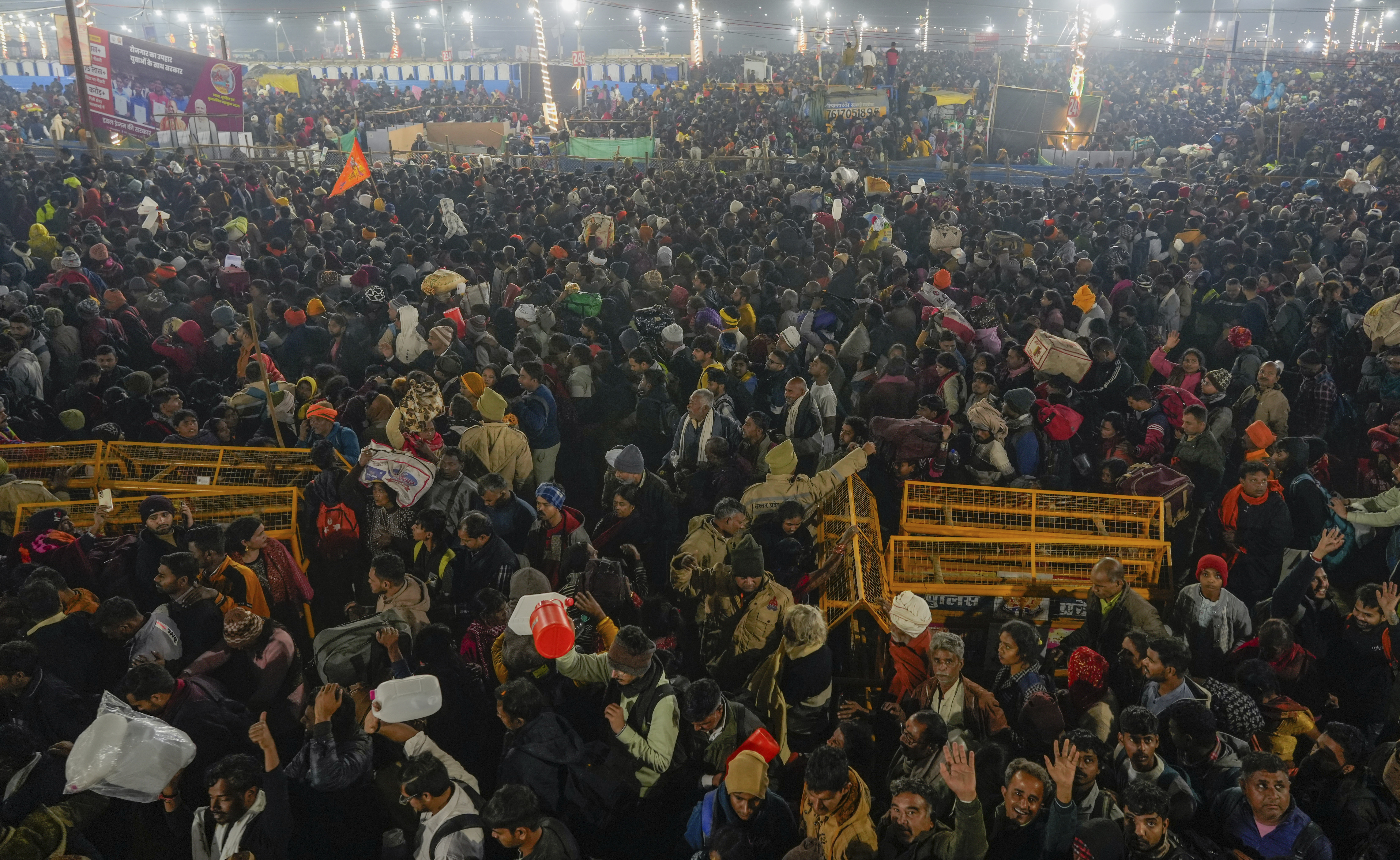 Hindu devotees gather for a holy dip by the banks of the Sangam, the confluence of the Ganges, the Yamuna and the mythical Saraswati rivers, on Mauni Amavasya' or new moon day during the Maha Kumbh festival in Prayagraj, Uttar Pradesh, India, Wednesay, Jan. 29, 2025. (AP Photo/Deepak Sharma)