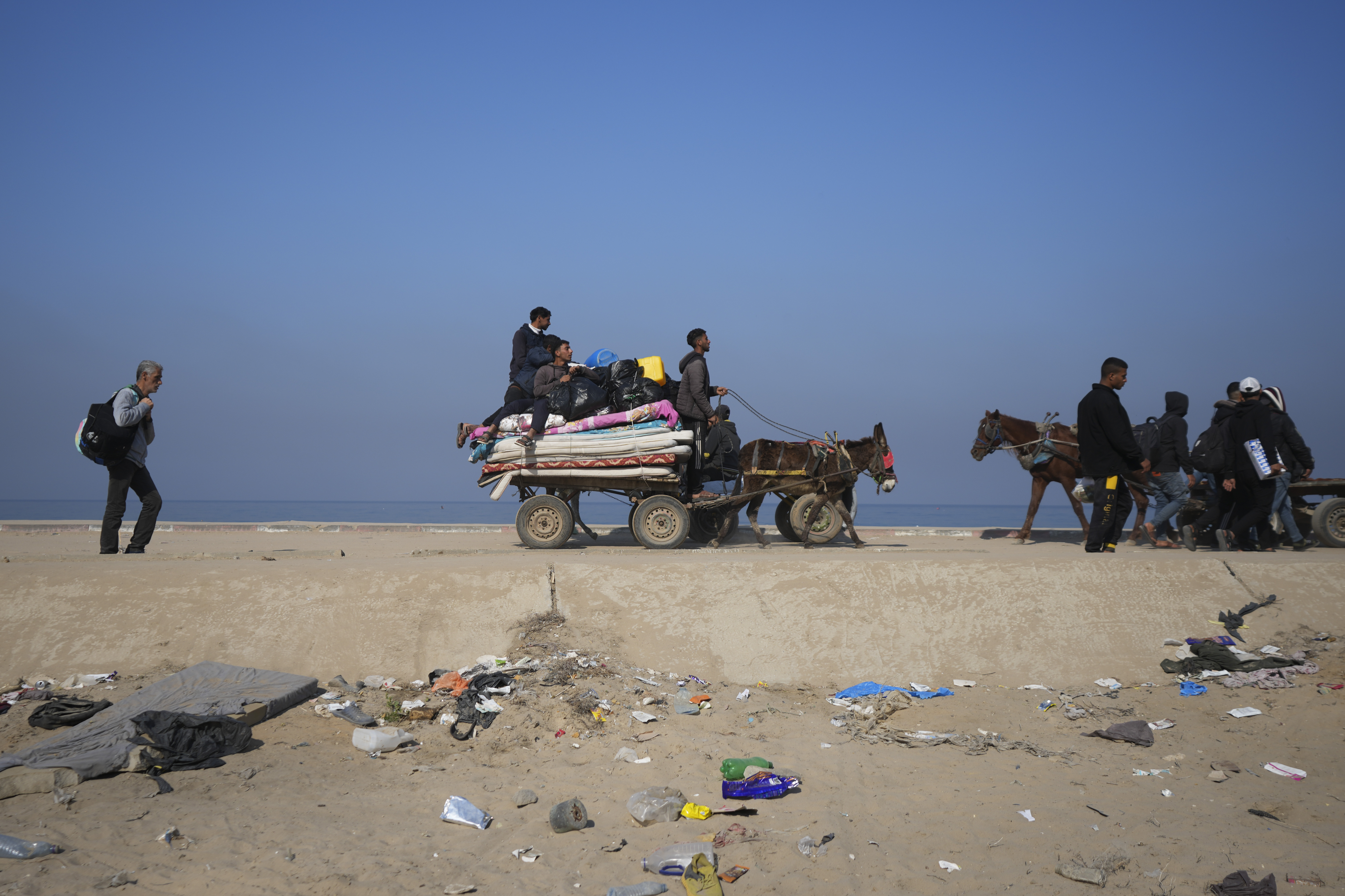 Displaced Palestinians walk on a road in central Gaza to return to their homes in the northern Gaza Strip, Wednesday, Jan. 29, 2025. (AP Photo/Abdel Kareem Hana)