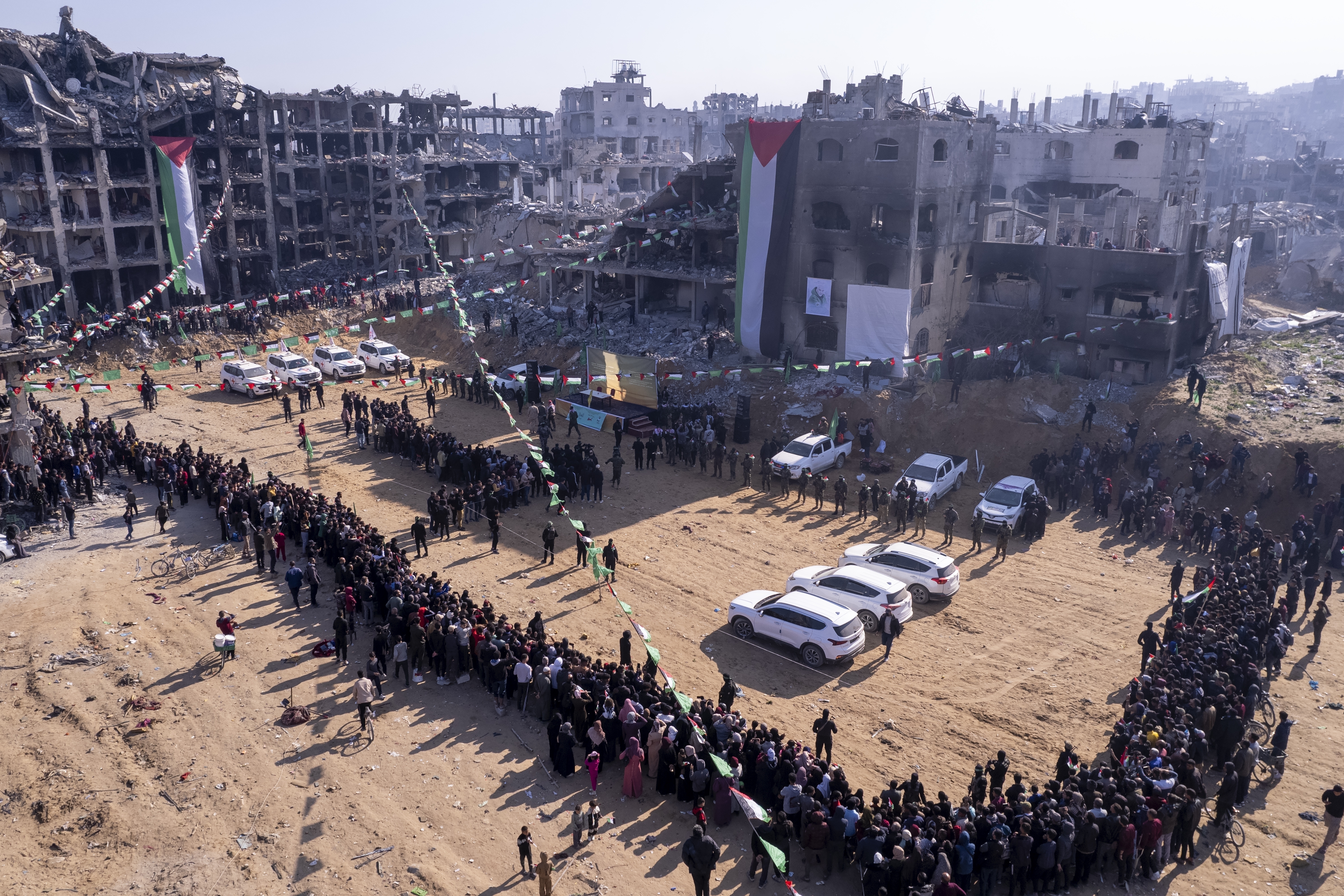 Red Cross vehicles, left, wait for the hand-over of Israeli soldier hostage Agam Berger at the Jabalya refugee camp in Gaza City, Thursday Jan. 30, 2025.(AP Photo/Mohammad Abu Samra)