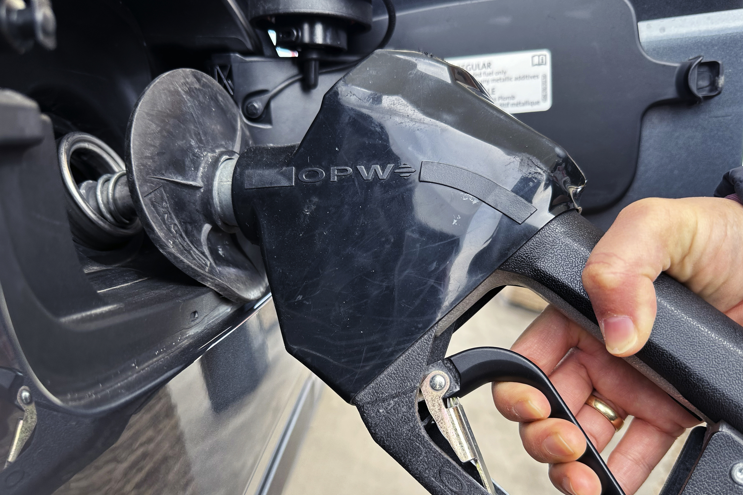 FILE - A customer pumps gas at a gas station in Mundelein, Ill., Feb. 8, 2024. (AP Photo/Nam Y. Huh, file)