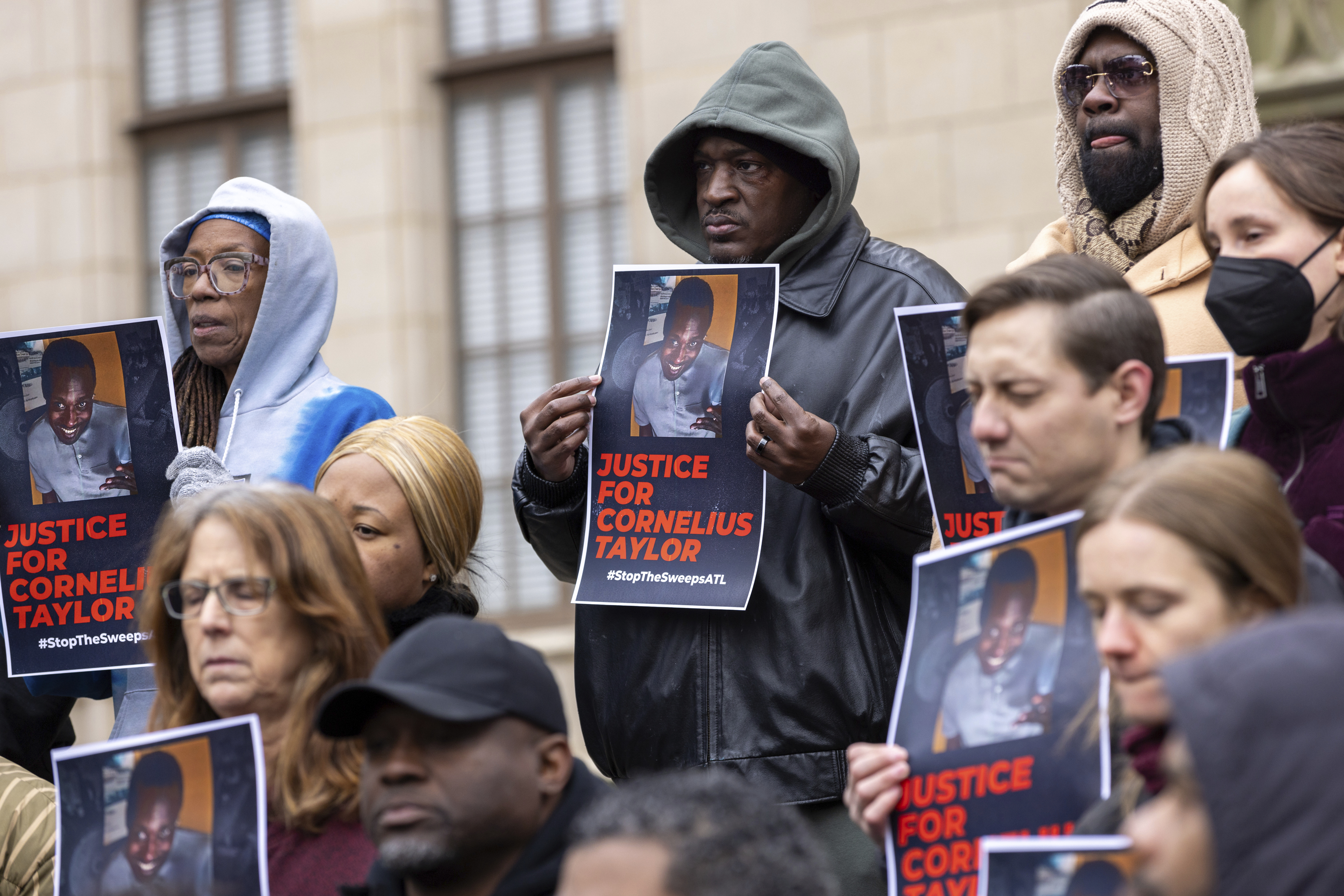 Family members and activists protest the death of Cornelius Taylor, an unhoused man killed when the city cleared an encampment last week, in front of City Hall in Atlanta on Thursday, Jan. 23, 2025. (Arvin Temkar/Atlanta Journal-Constitution via AP)