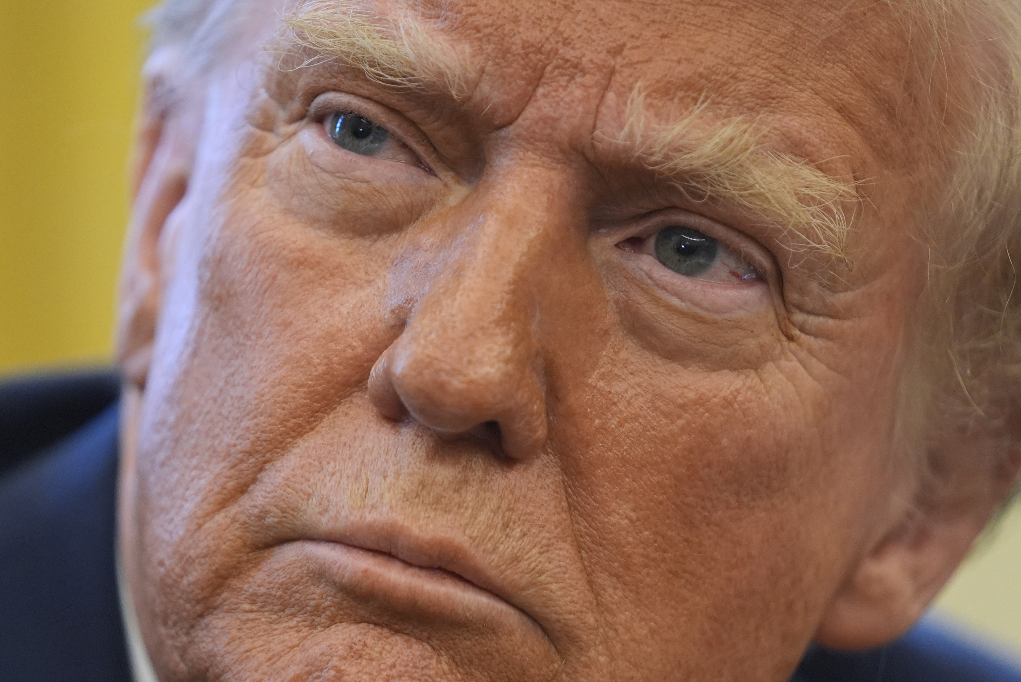 President Donald Trump listens to a question as he signs executive orders in the Oval Office at the White House, Thursday, Jan. 30, 2025, in Washington. (AP Photo/Evan Vucci)