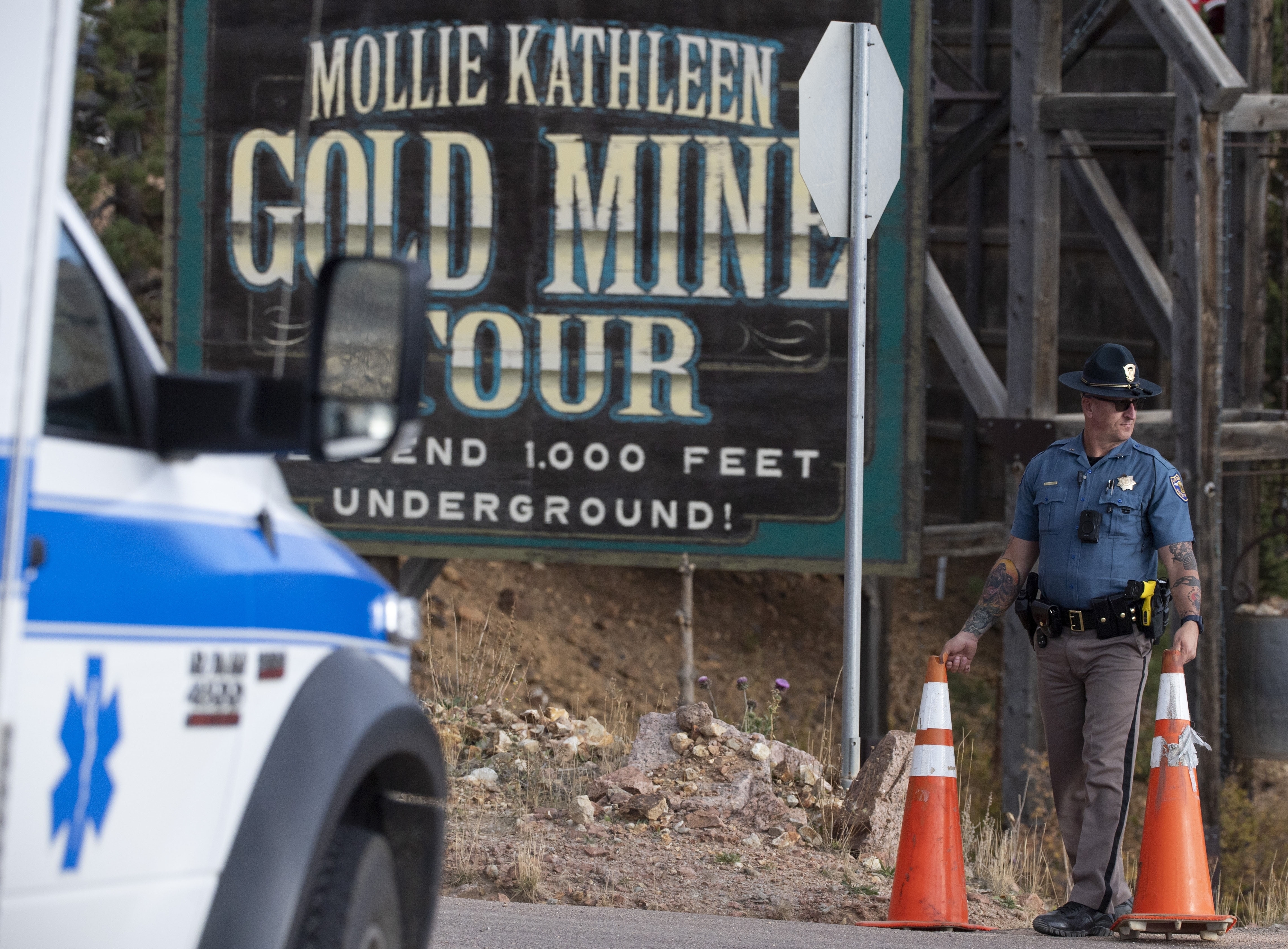 FILE - A police officer moves a barrier for an emergency vehicle, Oct. 9, 2024, at Mollie Kathleen Gold Mine in Cripple Creek, Colo. (Arthur H. Trickett-Wile/The Gazette via AP, File)