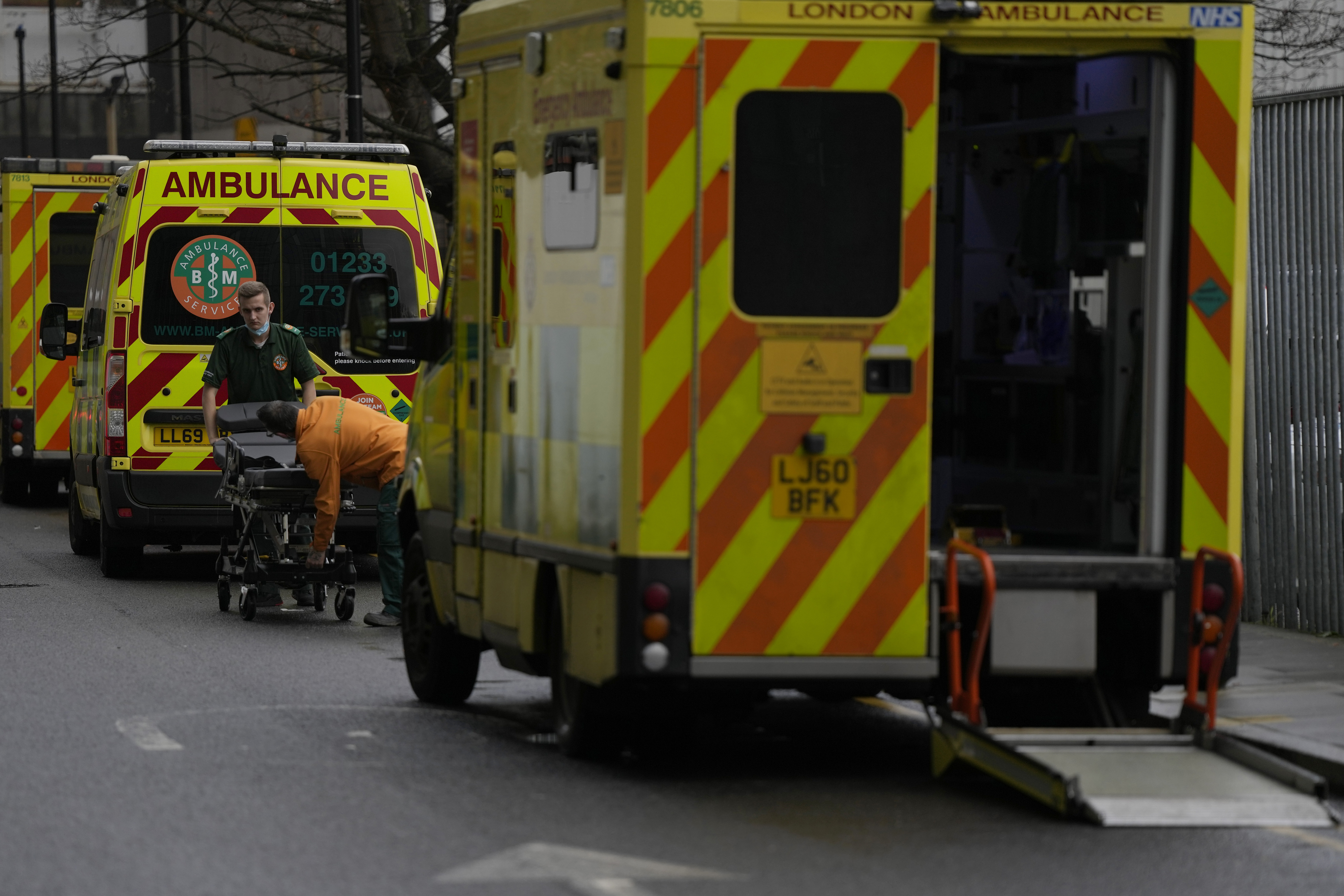 FILE -Ambulance staff adjust a stretcher as other ambulances wait outside the Royal London Hospital in east London, Jan. 4, 2023. (AP Photo/Alastair Grant, File)