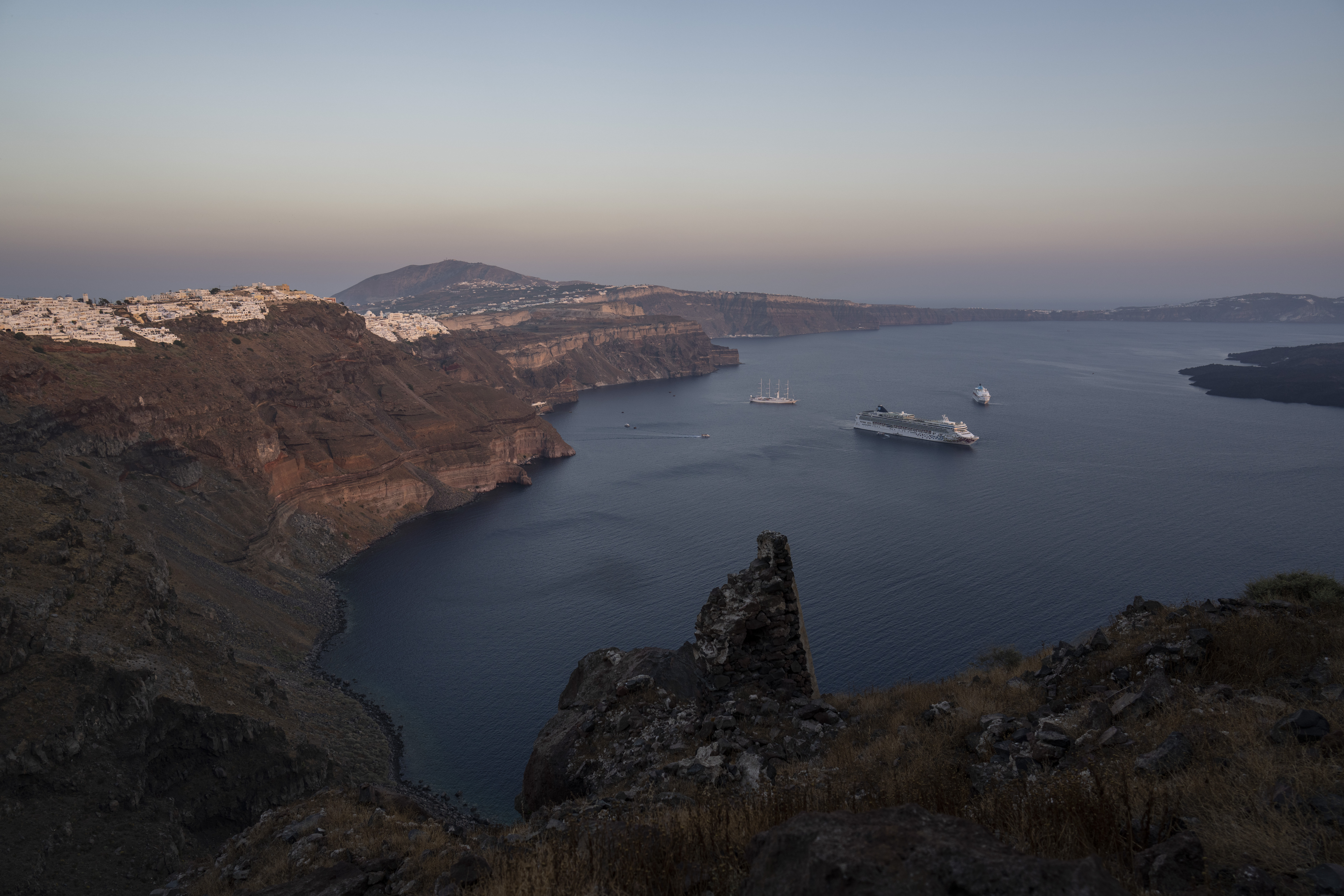 FILE - Ruins of a settlement, including a former Catholic monastery, lie on the rocky promontory of Skaros on the Greek island of Santorini, Wednesday, June 15, 2022. (AP Photo/Petros Giannakouris, File)