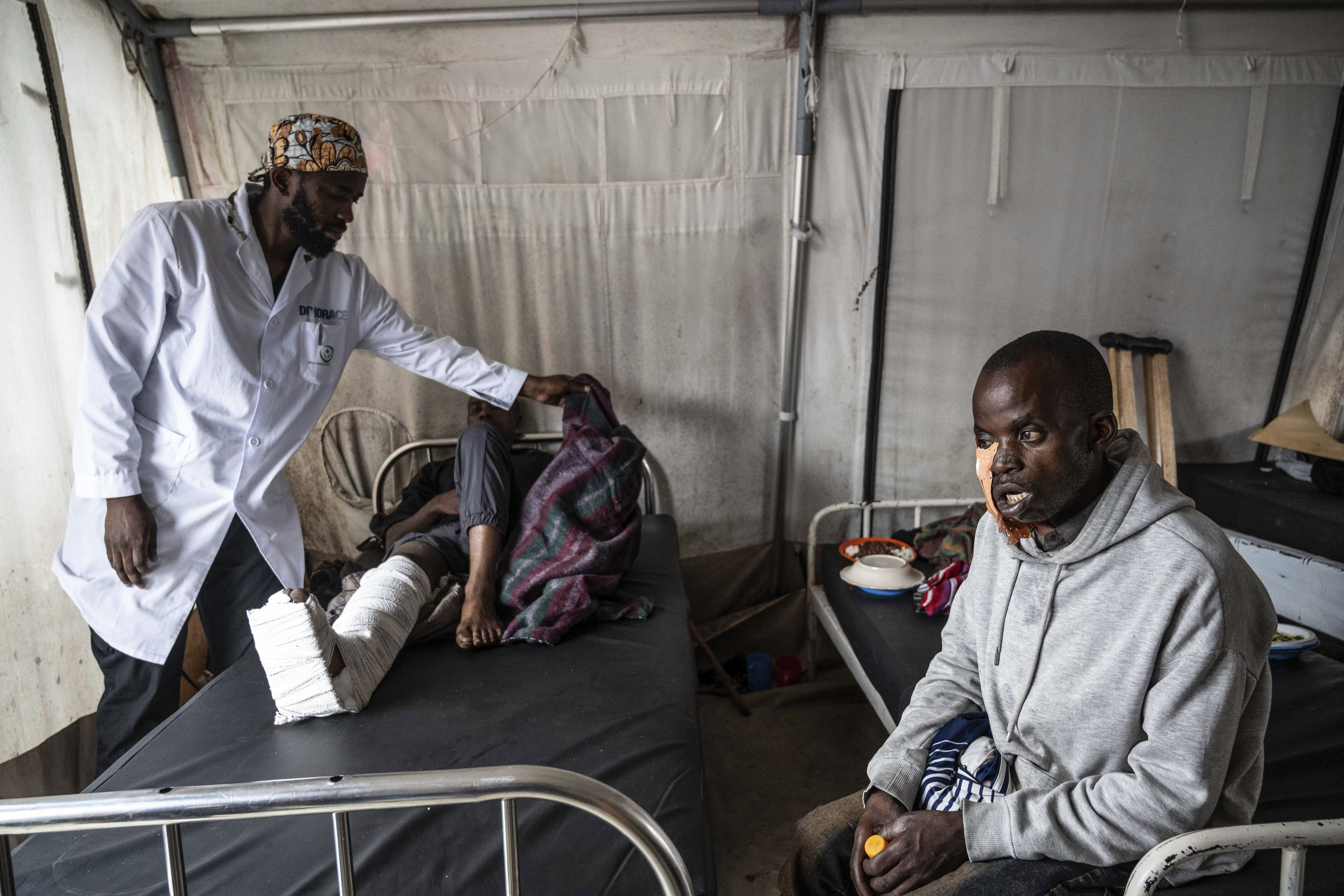 Medics treat a man wounded during fighting between Congolese government troops and M23 rebel forces in Goma's Kyeshero hospital Saturday, Feb. 1, 2025. (AP Photo/Moses Sawasawa)