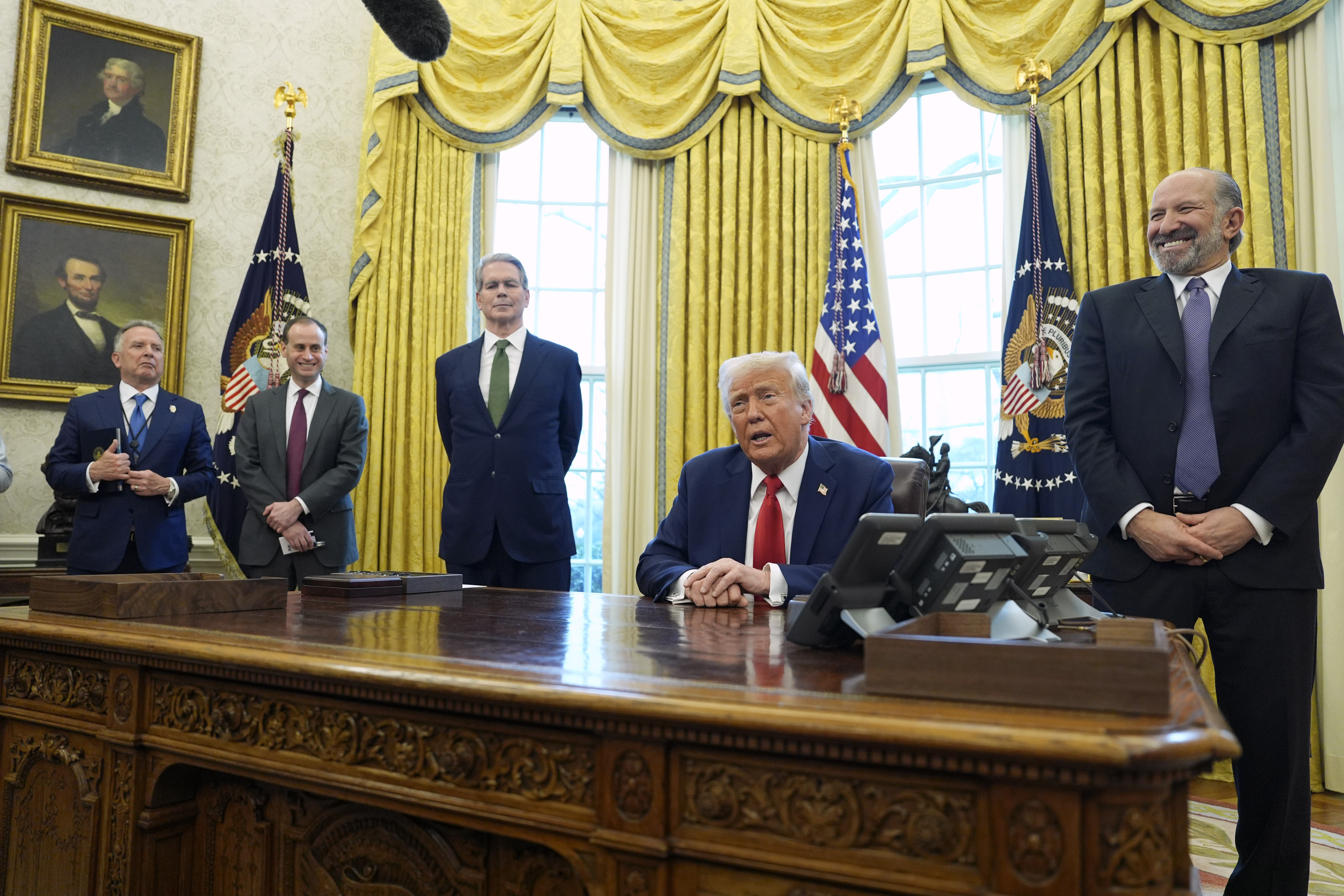 President Donald Trump speaks as Steve Witkoff, special envoy for the Middle East, from left, White House staff secretary Will Scharf, Treasury Secretary Scott Bessent and Commerce Secretary nominee Howard Lutnick listen as Trump signs executive orders in the Oval Office of the White House, Monday, Feb. 3, 2025, in Washington. (AP Photo/Evan Vucci)