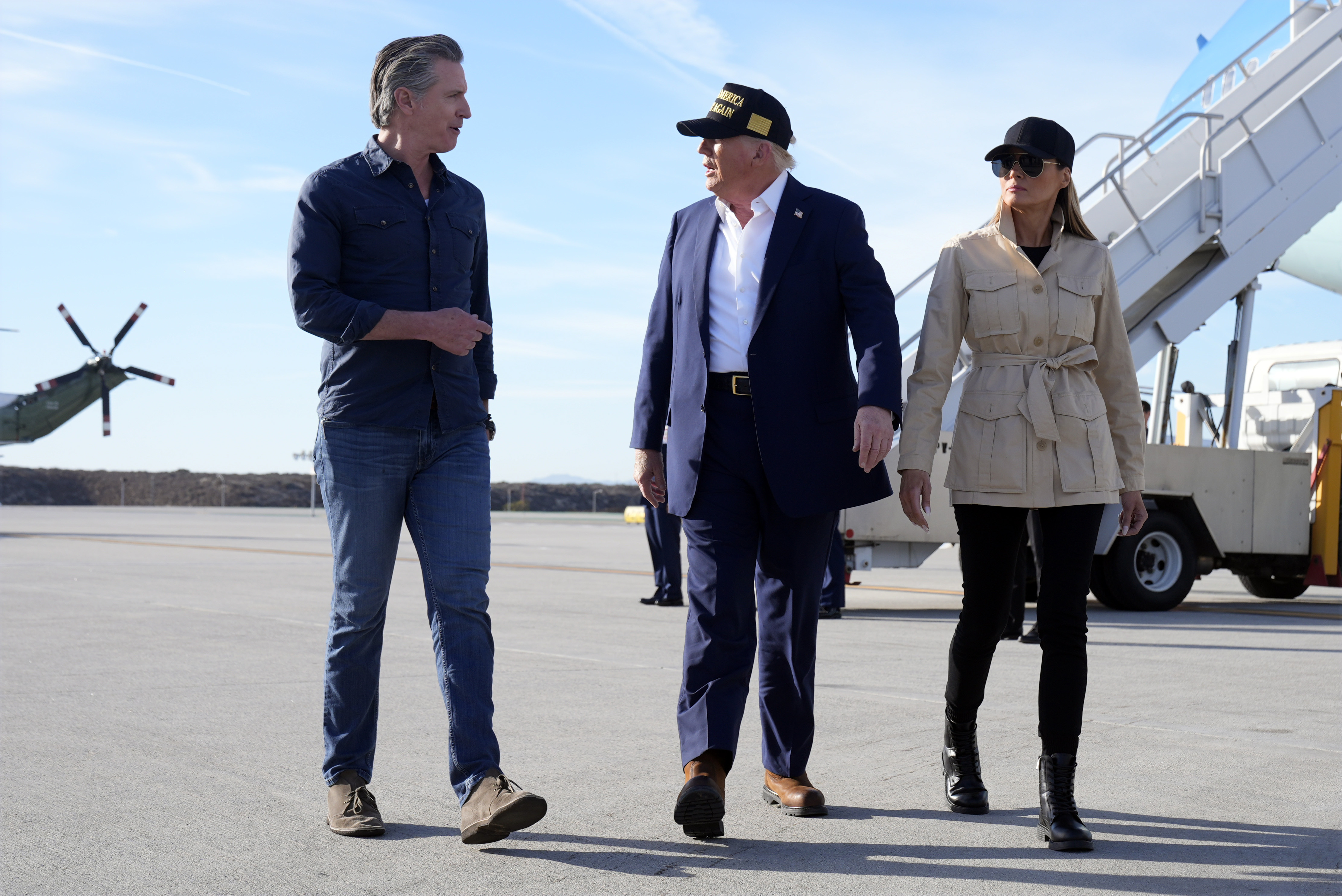 FILE - President Donald Trump and first lady Melania Trump walk with California Gov. Gavin Newsom after arriving on Air Force One at Los Angeles International Airport in Los Angeles, Jan. 24, 2025. (AP Photo/Mark Schiefelbein, File)