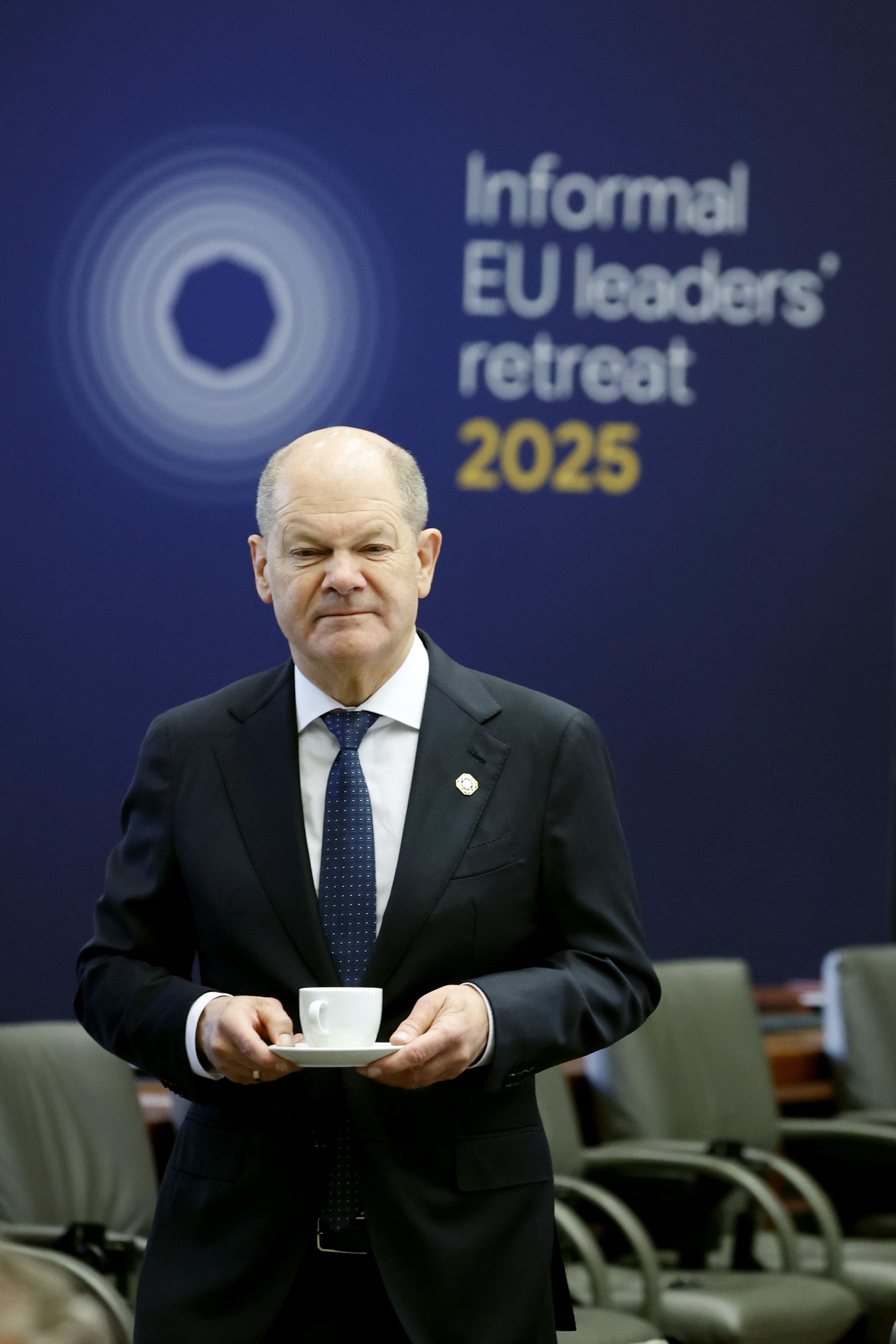 Germany's Chancellor Olaf Scholz holds a cup and saucer during an EU summit at the Egmont Palace in Brussels, Monday, Feb. 3, 2025. (AP Photo/Geert Vanden Wijngaert)