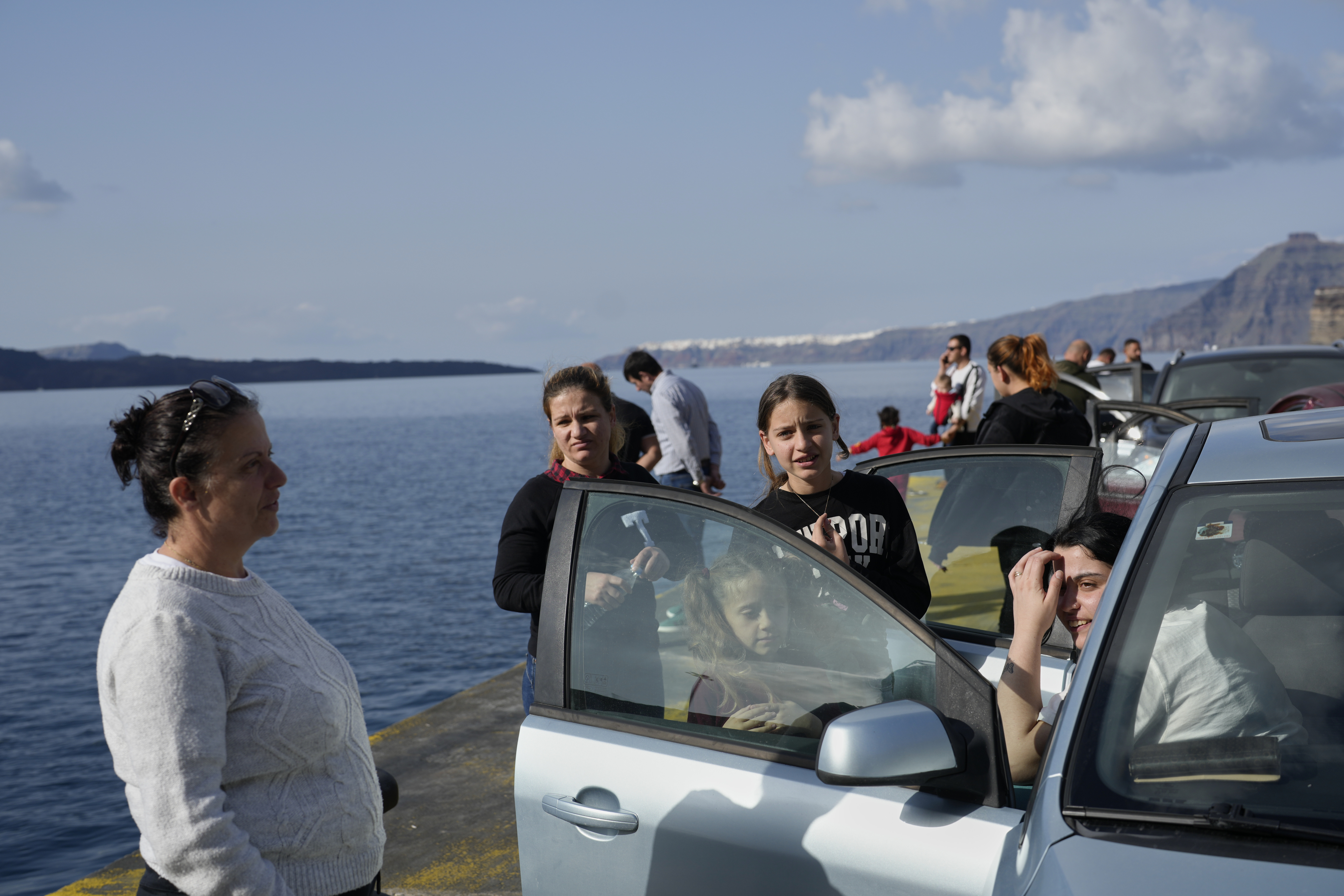 People wait for the arrival of a regularly scheduled ferry to Athens' port of Piraeus, after a spike in seismic activity raised concerns about a potentially powerful earthquake in Santorini, southern Greece, Monday, Feb. 3, 2025. (AP Photo/Petros Giannakouris)