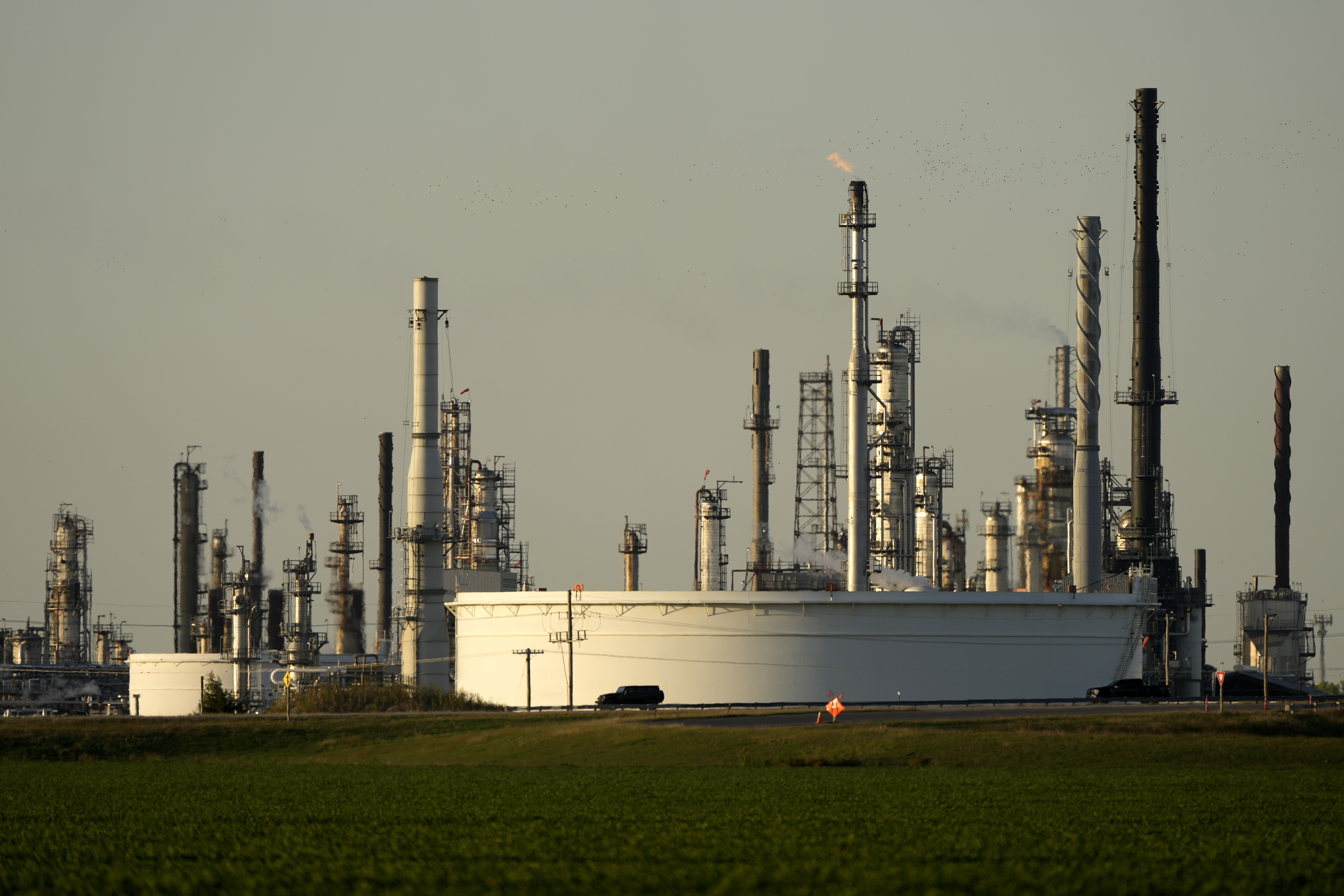 FILE - A motorist drives past the CHS oil refinery Sept. 28, 2024, in McPherson, Kan. (AP Photo/Charlie Riedel, File)