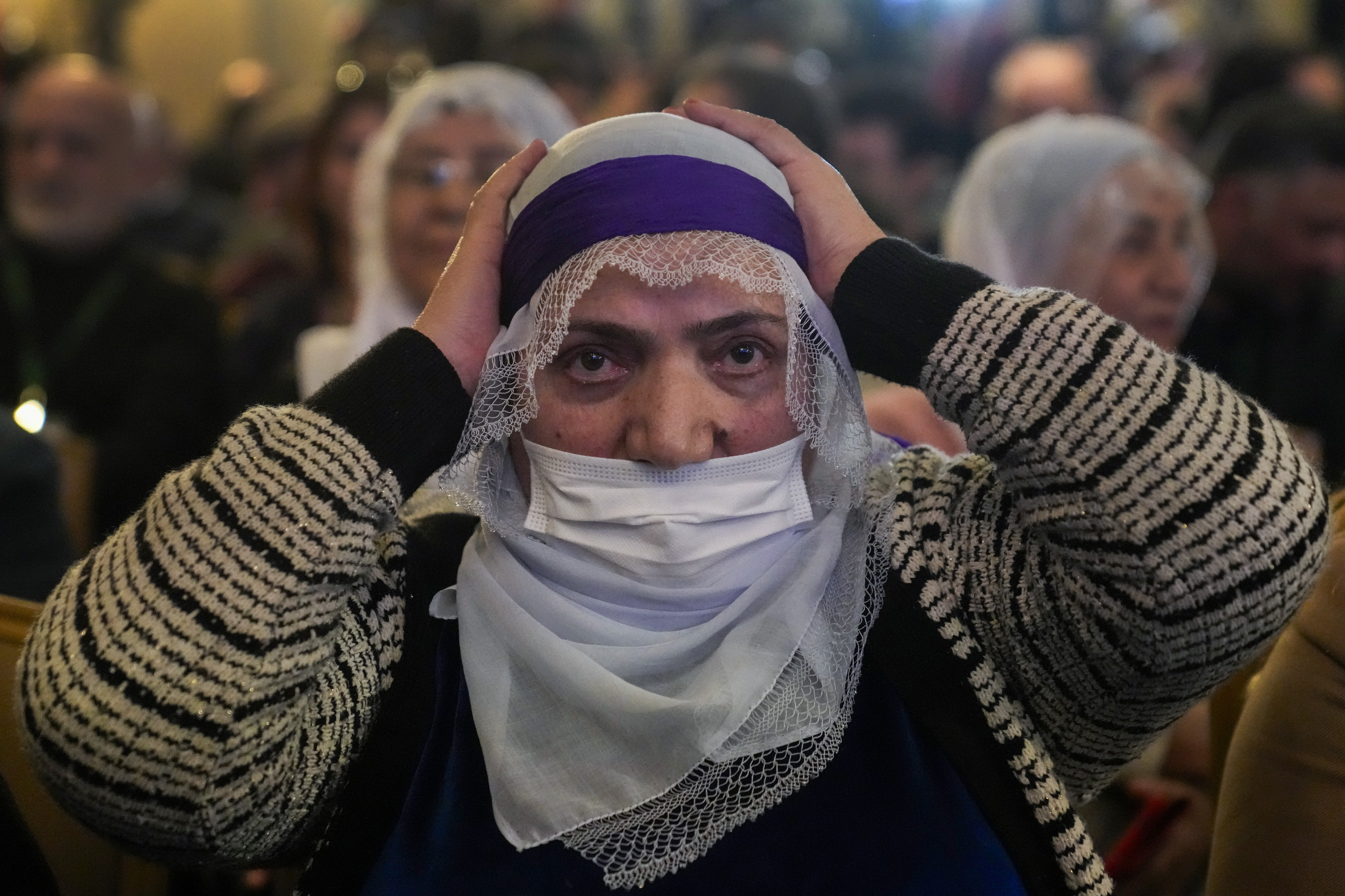 A supporter of Pro-Kurdish Peoples' Equality and Democracy Party, or DEM, gestures as a delegation members release a statement from the jailed leader of the rebel Kurdistan Workers' Party, or PKK, Abdullah Ocalan, in Istanbul, Turkey, Thursday, Feb. 27, 2025. (AP Photo/Khalil Hamra)