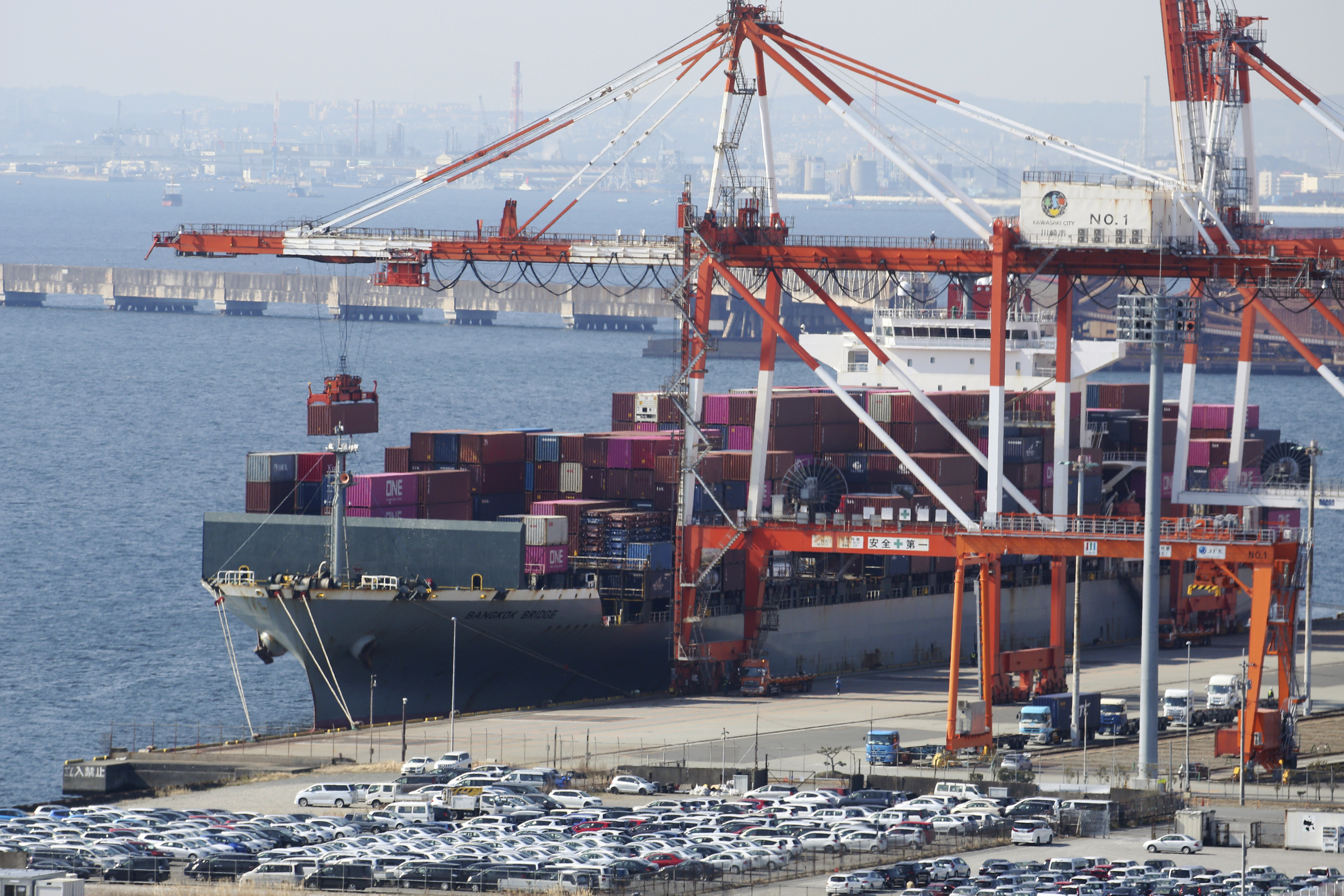 FILE - A container ship is loaded and unloaded at a container terminal at a port of Kawasaki near Tokyo on March 9, 2022. (AP Photo/Koji Sasahara, File)